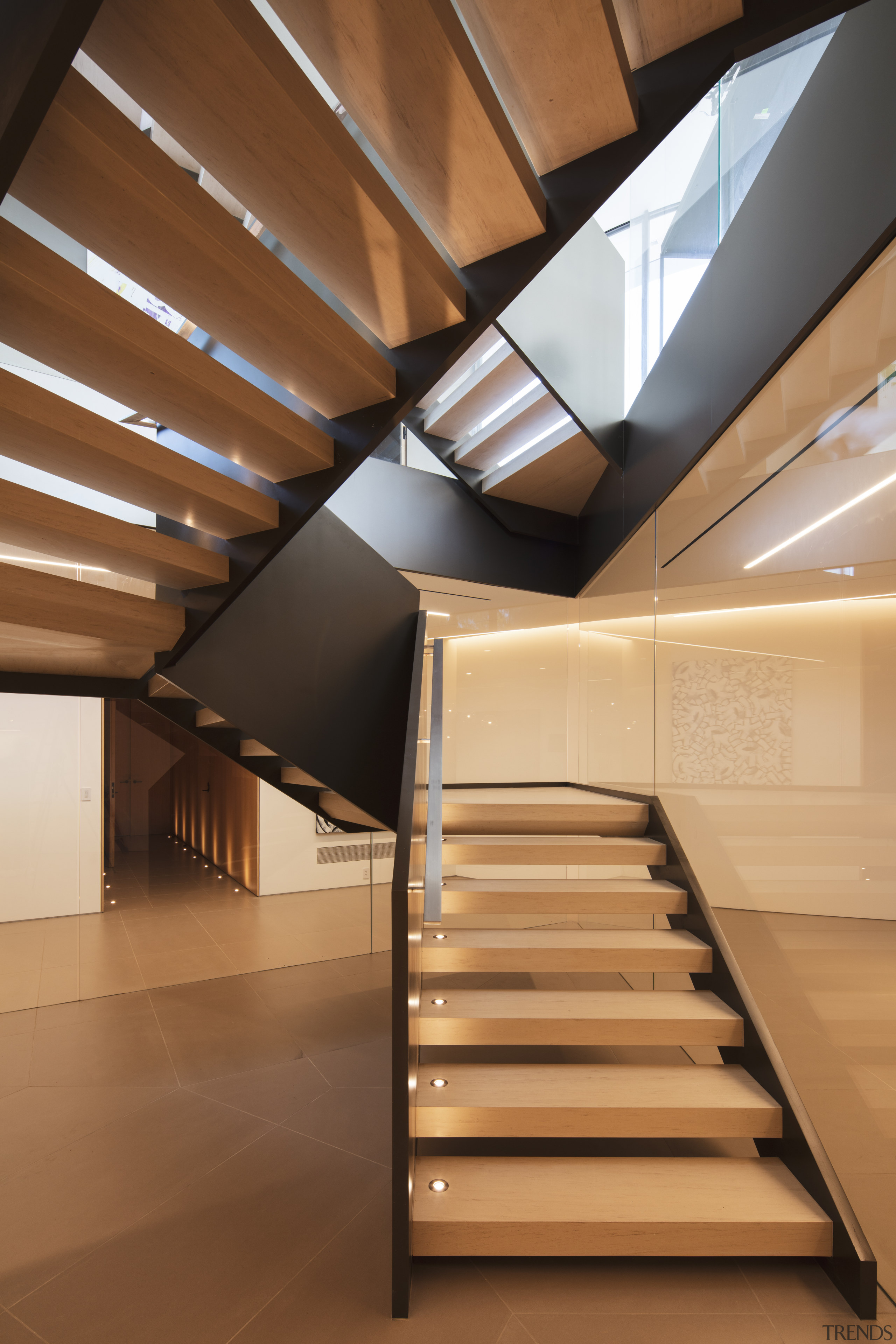 ​​​​​​​A prominent staircase runs through the central point architecture, building, ceiling, daylighting, floor, handrail, house, interior design, line, loft, room, stairs, window, brown, orange