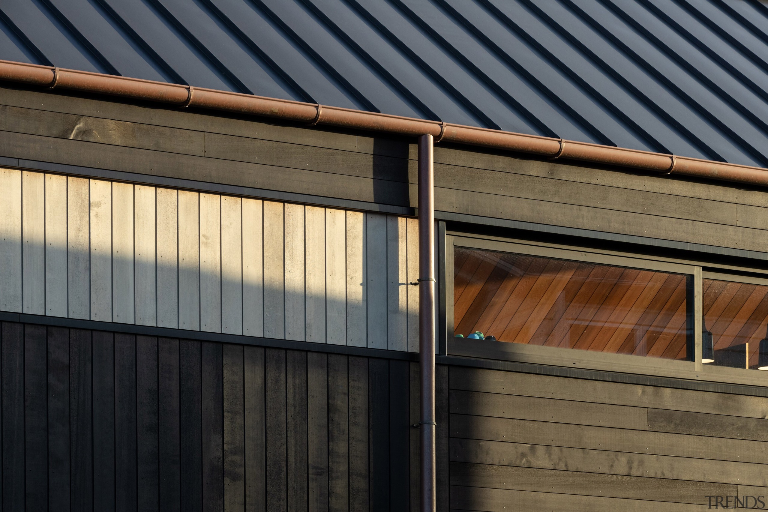 Timber cladding and glimpsed interior wood ceiling – 