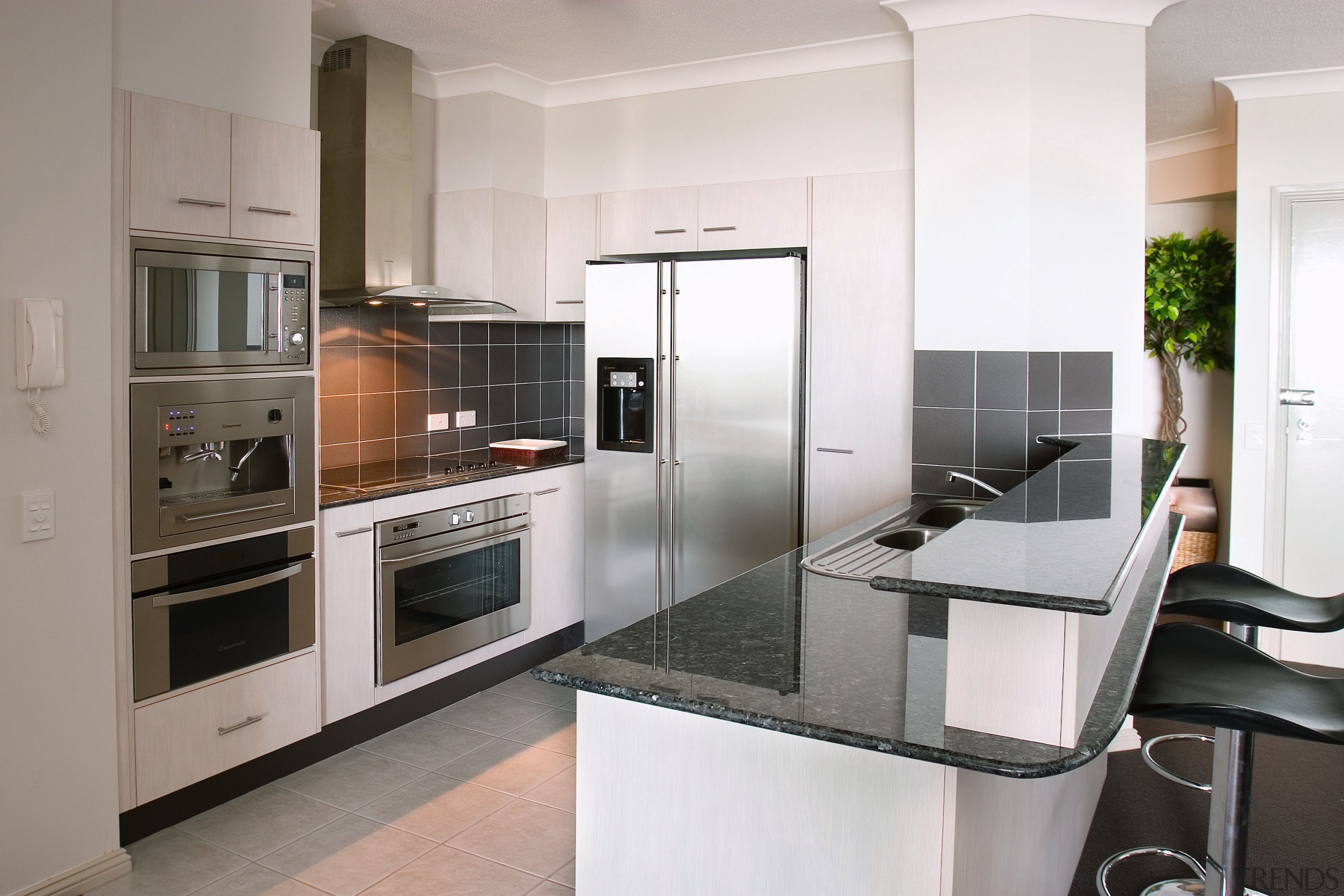 A view of an apartment complex with Kleenmaid cabinetry, countertop, cuisine classique, home appliance, interior design, kitchen, kitchen appliance, real estate, gray