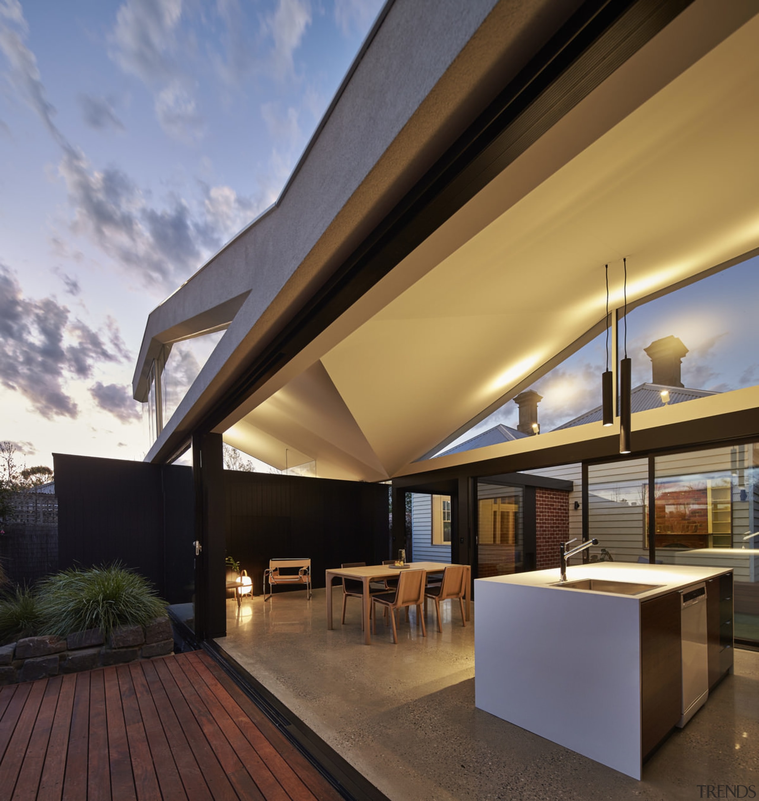 Another view of the home at dusk - architecture, ceiling, daylighting, home, house, interior design, lighting, real estate, roof, brown