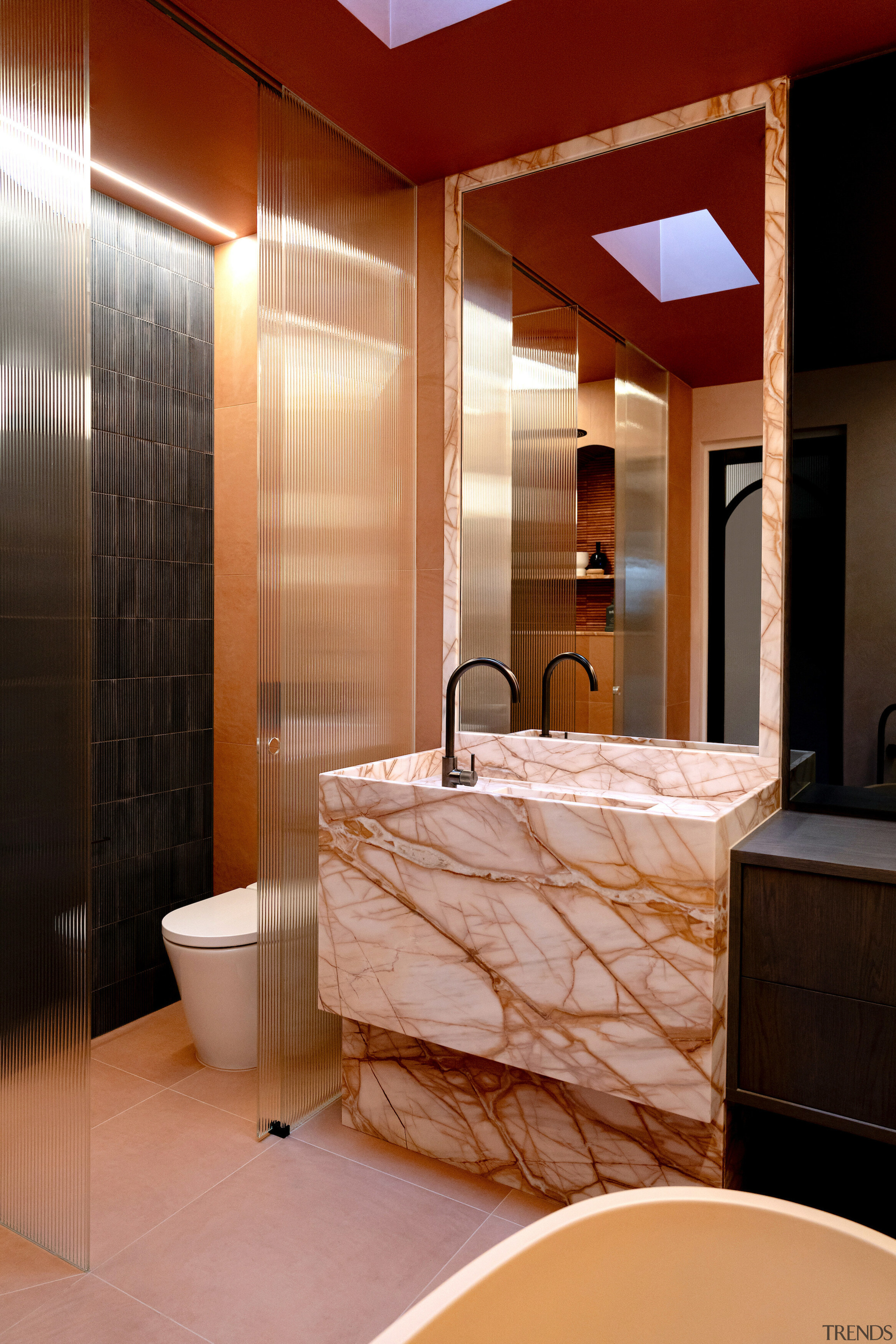 A skylight bathes the exotic marble in natural 