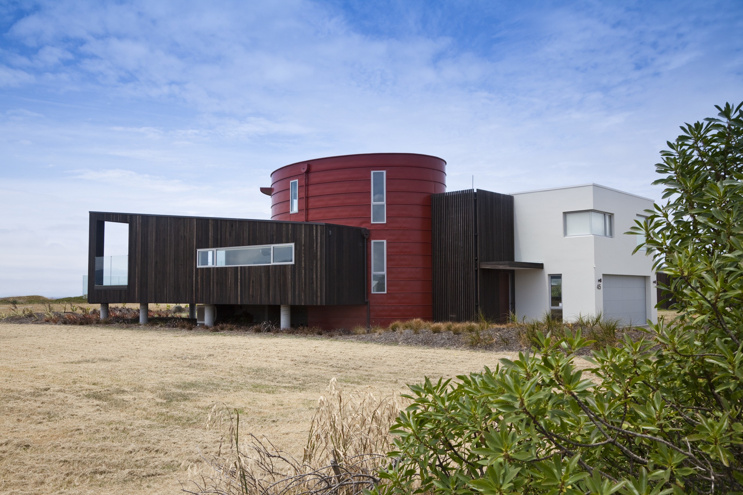 View of red, black and white beach house architecture, facade, home, house, property, real estate, sky, teal