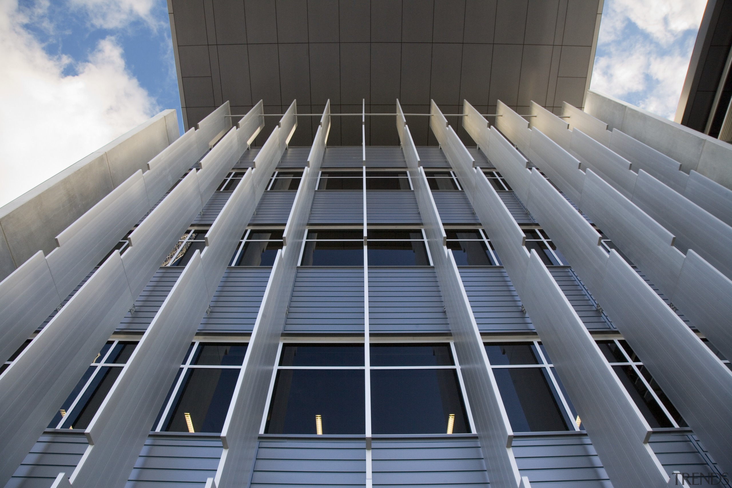 A view of the exterior of the greensquare architecture, building, commercial building, condominium, corporate headquarters, daylighting, daytime, facade, headquarters, landmark, line, metropolis, metropolitan area, sky, skyscraper, structure, symmetry, tower block, urban area, gray