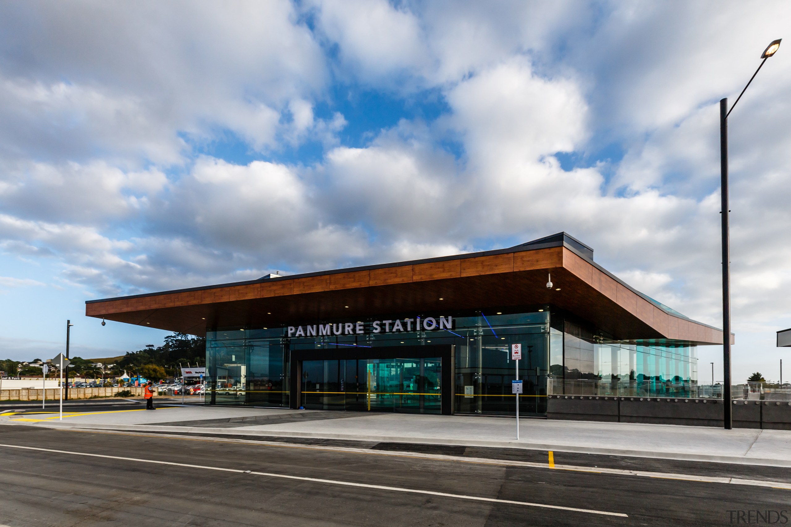 A substantial, timber-clad gullwing roof appears to float architecture, building, cloud, infrastructure, real estate, sky, transport, gray