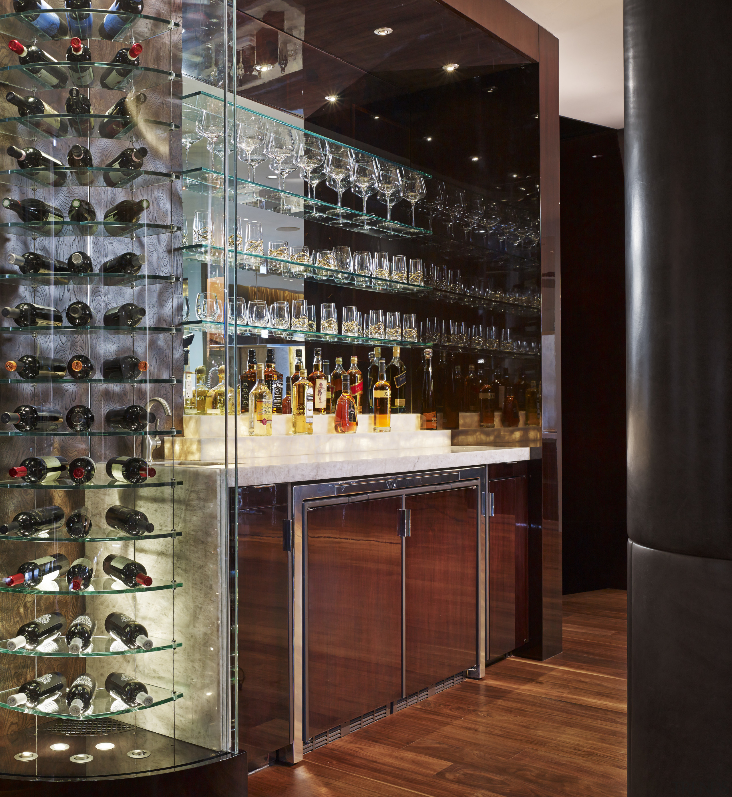 Adjacent to the kitchen in this apartment is glass, interior design, liquor store, wine cellar, winery, black