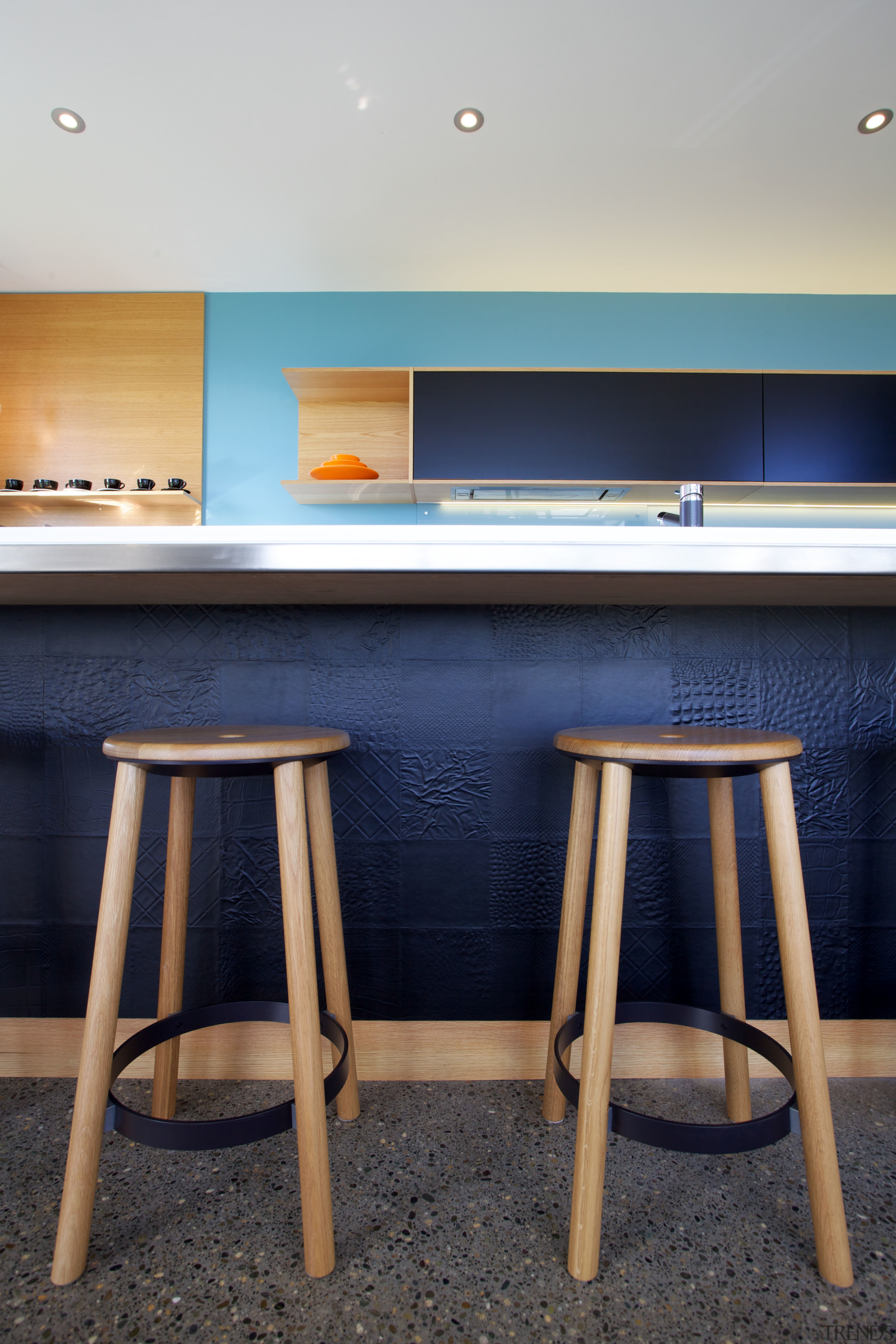 Surface textures and edge profiles reflect the attention chair, floor, flooring, furniture, interior design, product design, room, table, wood, blue