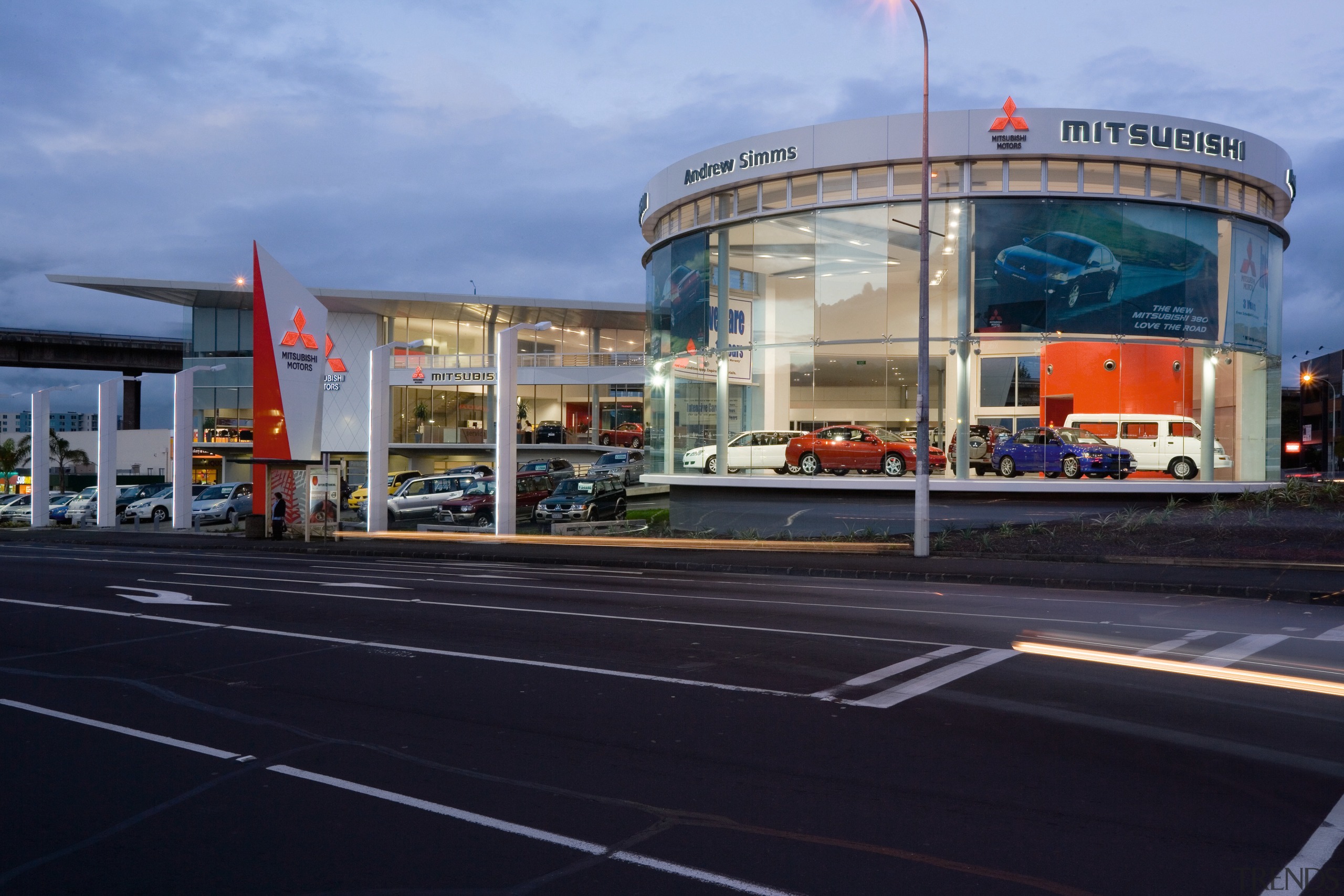 A view of the Mitsubishi Motors building. - building, car, metropolitan area, mixed use, sky, black, teal