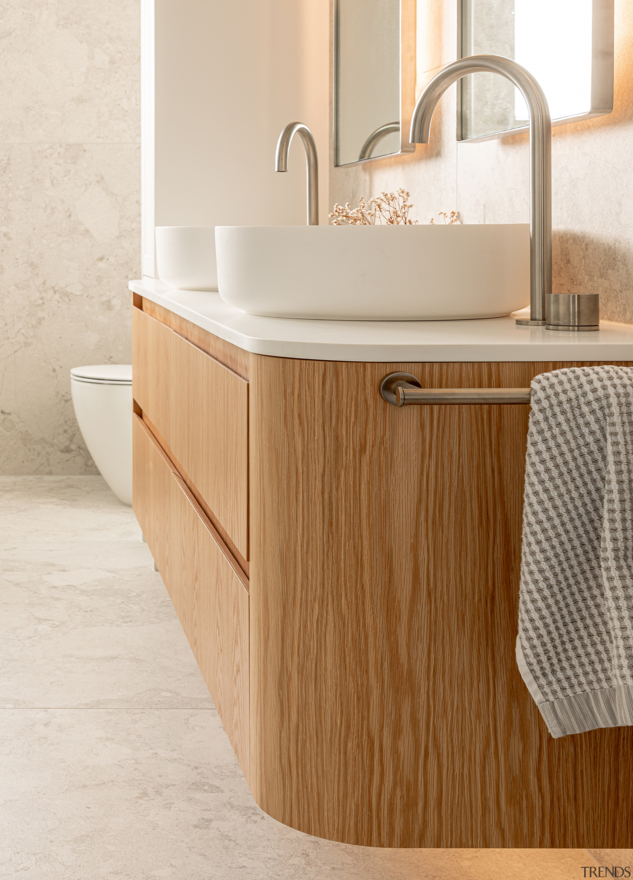 The curvaceous wall-hung double vanity is finished in 