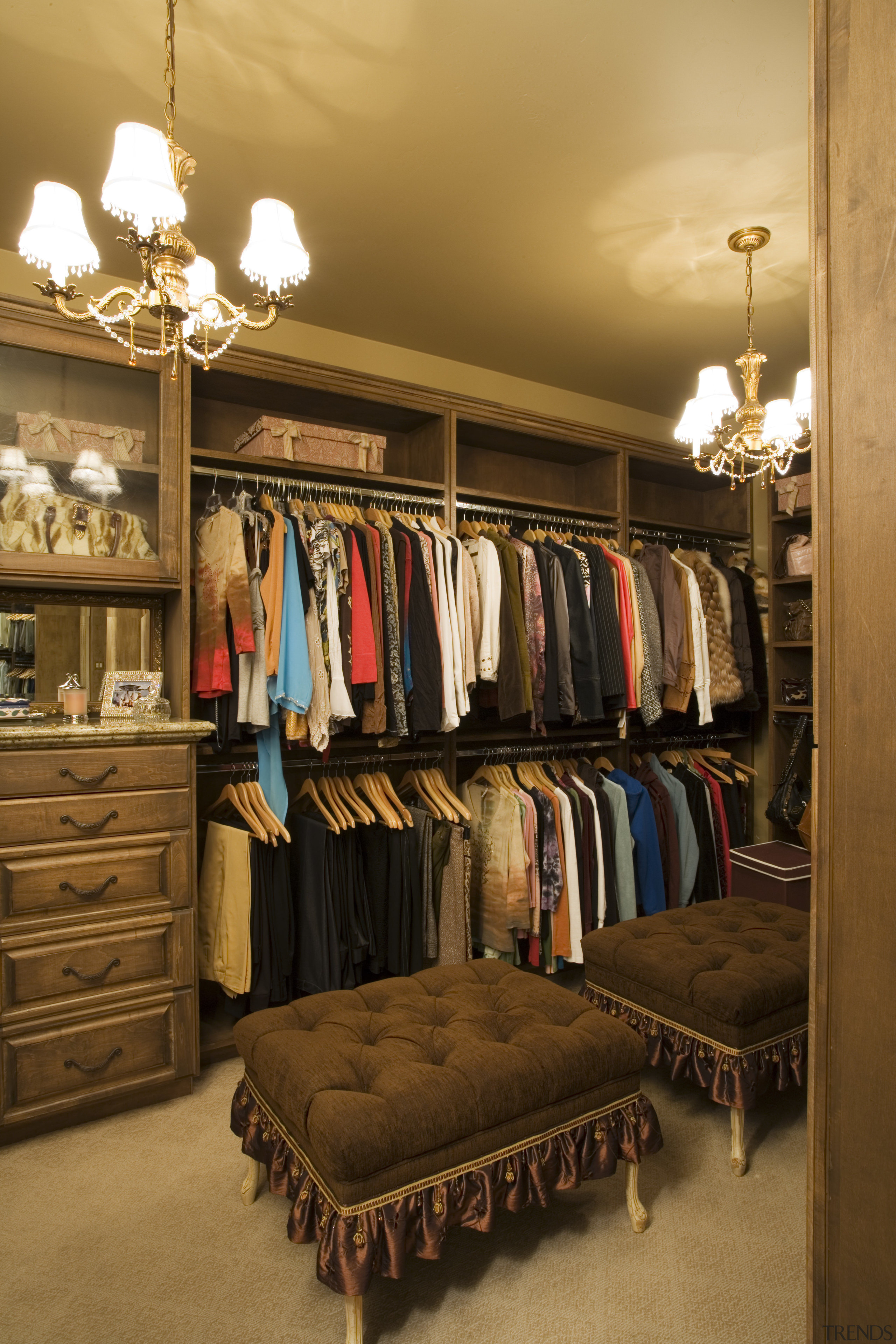 A view of the walk in wardrom accessed boutique, closet, furniture, interior design, room, brown, orange