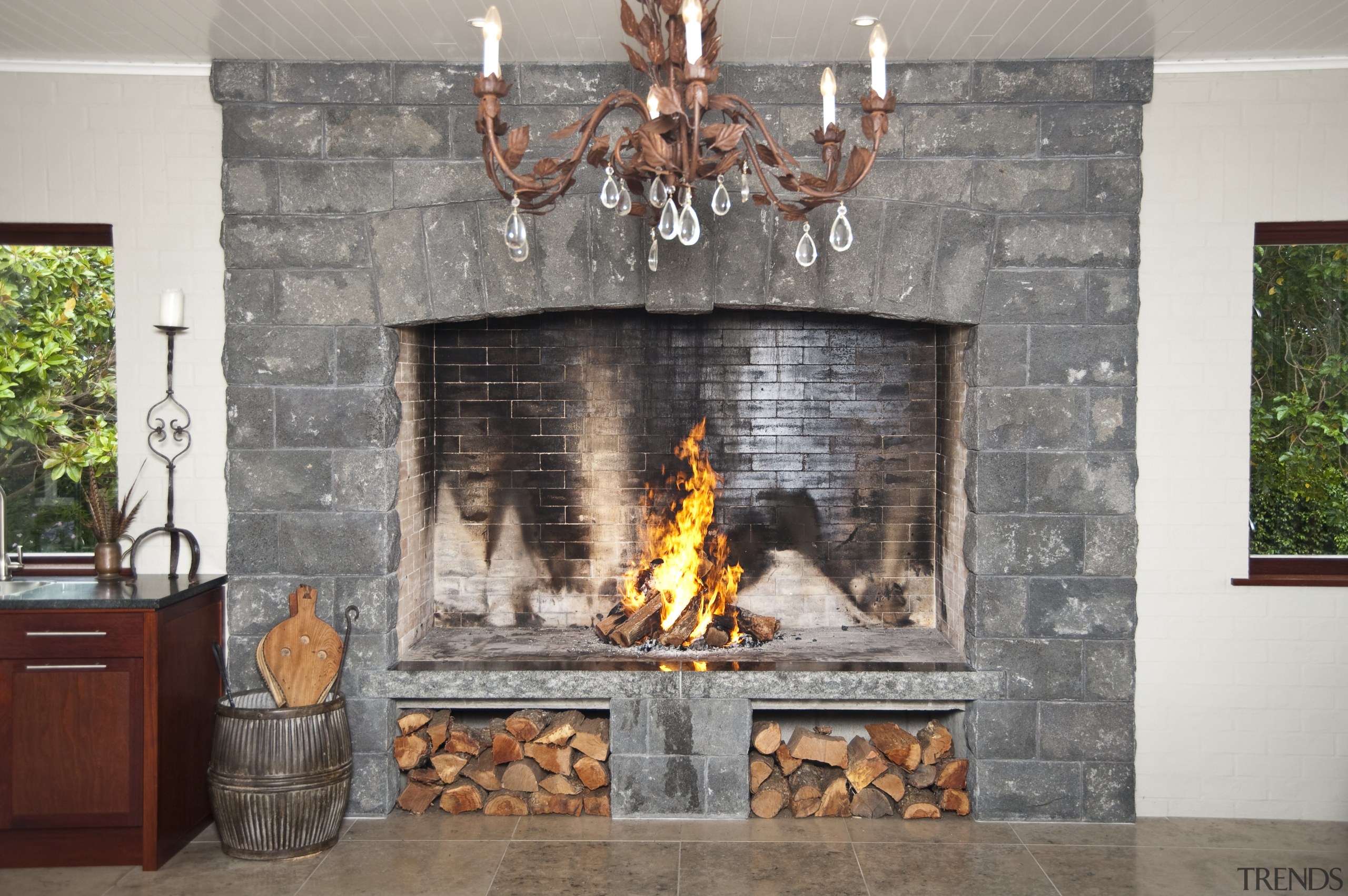 In the dining area of the home this fireplace, hearth, interior design, wood burning stove, gray