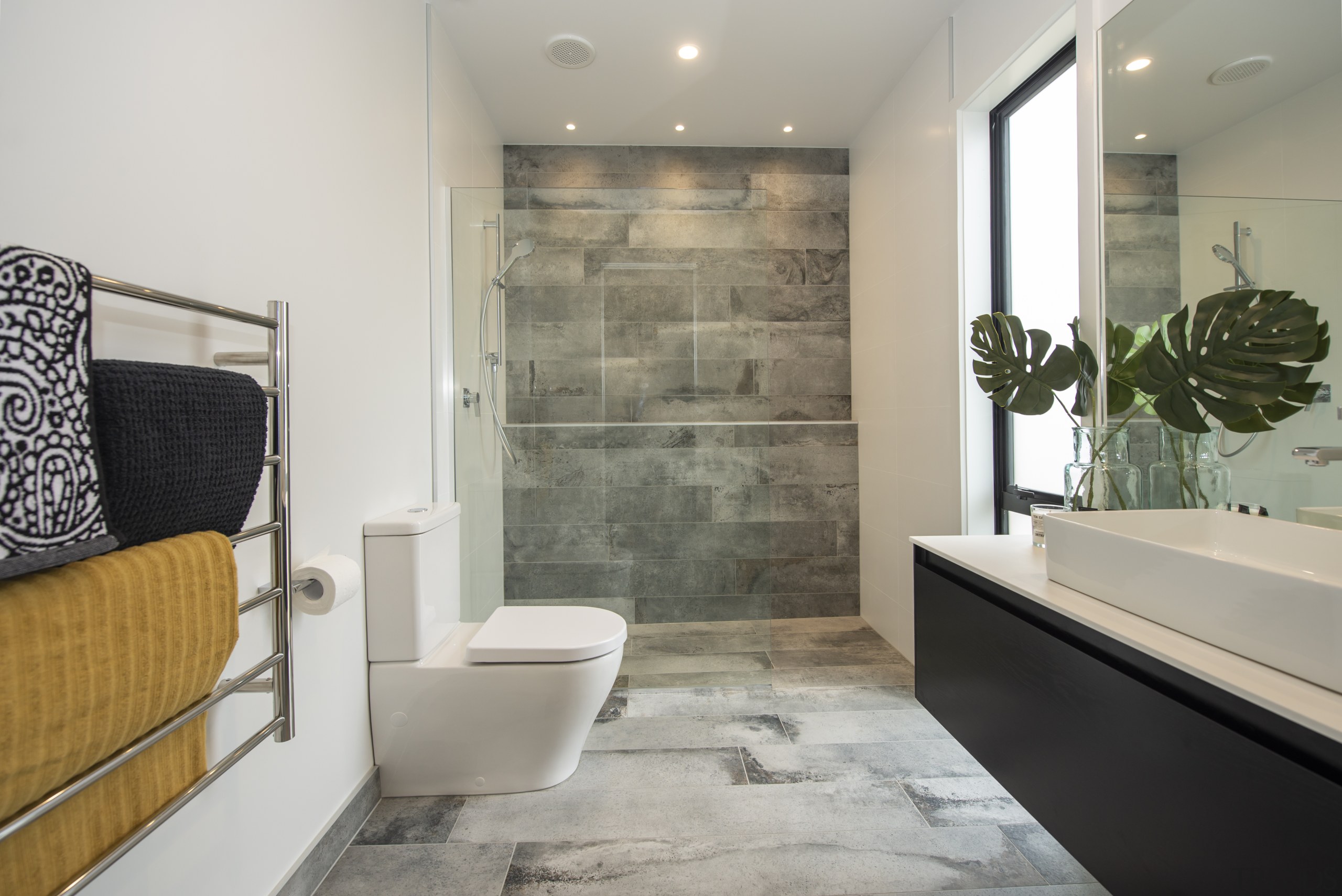 ​​​​​​​Feature tiles create a relaxed ambience in this architecture, bathroom, bathtub, building, ceiling, floor, flooring, furniture, home, house, interior design, property, real estate, room, tile, wall, gray