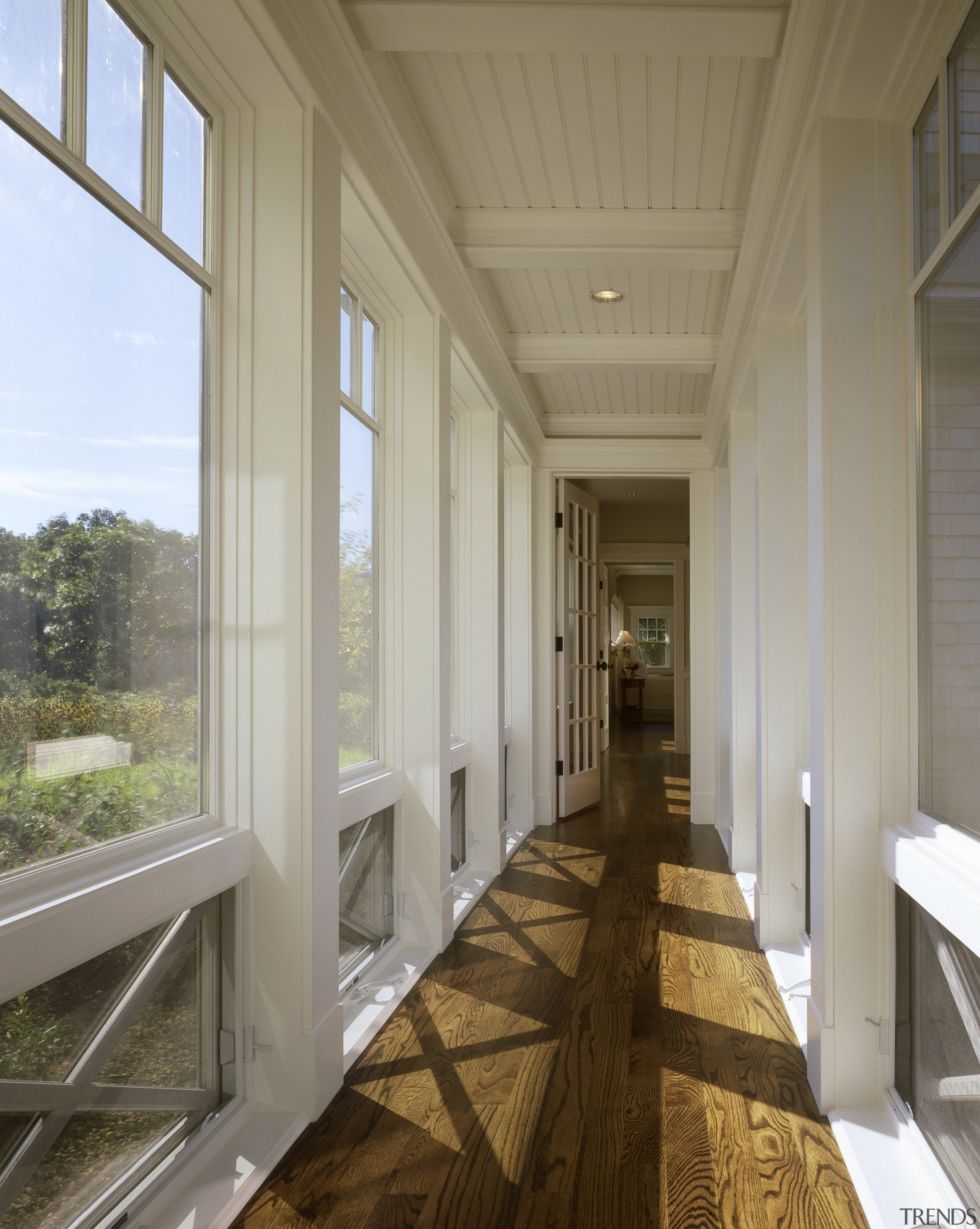 View of a hallway which features oak flooring, architecture, ceiling, daylighting, estate, floor, flooring, home, house, interior design, porch, real estate, window, wood flooring, gray, brown