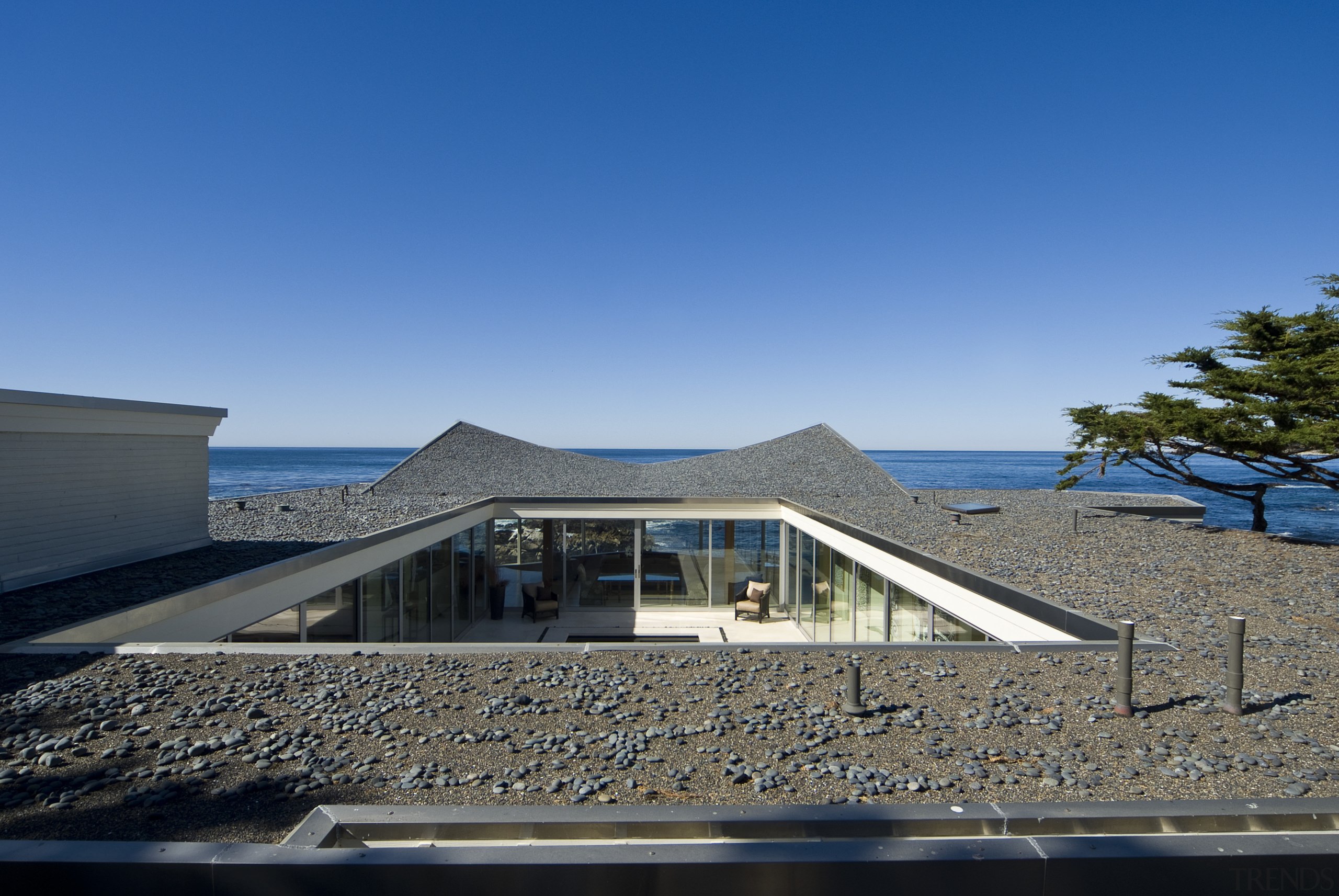 View of the oceanfront Butterfly House in Carmel architecture, building, cloud, condominium, estate, home, horizon, house, property, real estate, residential area, roof, sea, sky, water, blue