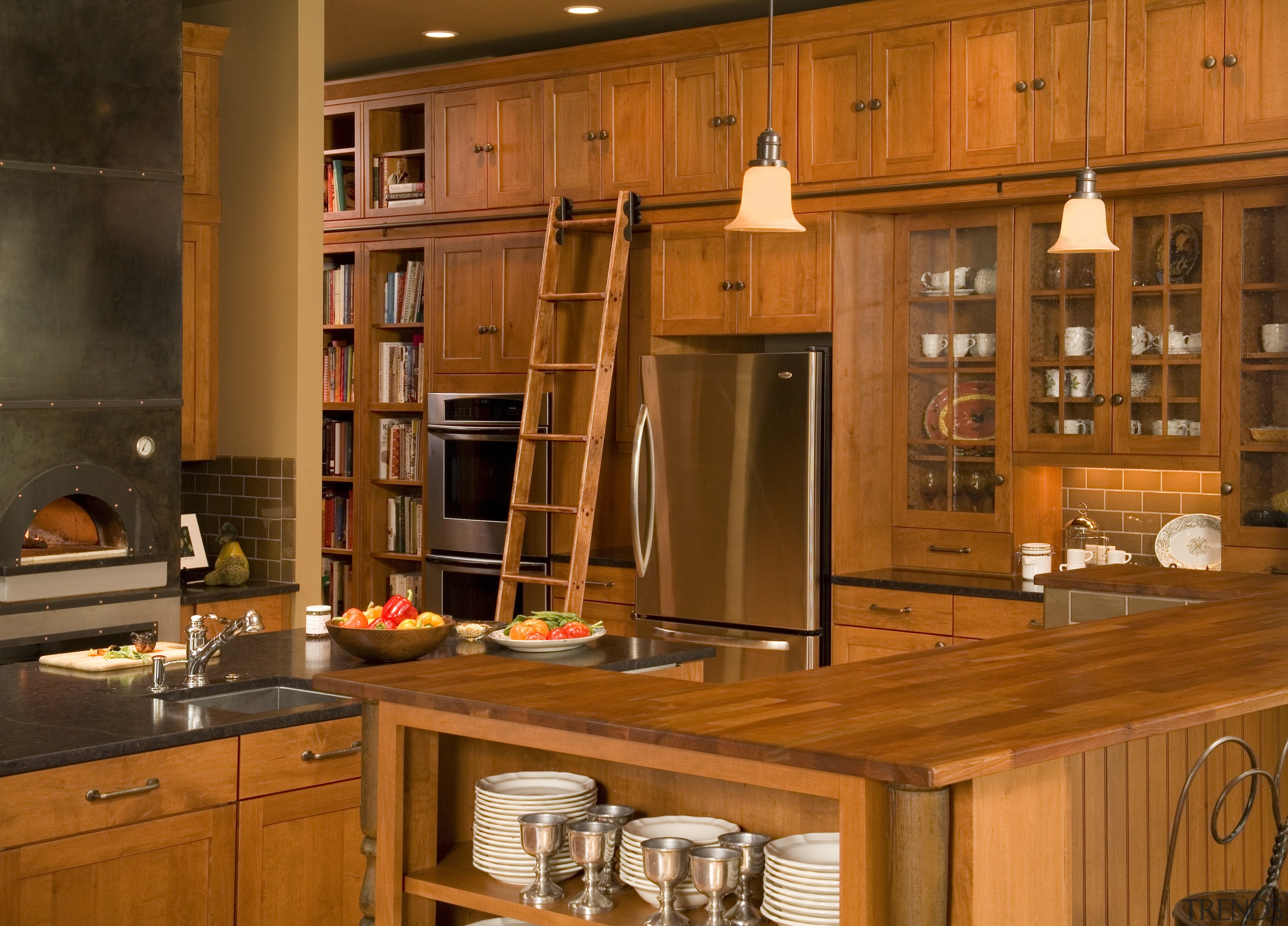 View of a Northwestern-styled kitchen with extensive wood cabinetry, countertop, cuisine classique, furniture, hardwood, interior design, kitchen, room, under cabinet lighting, wood, wood stain, brown