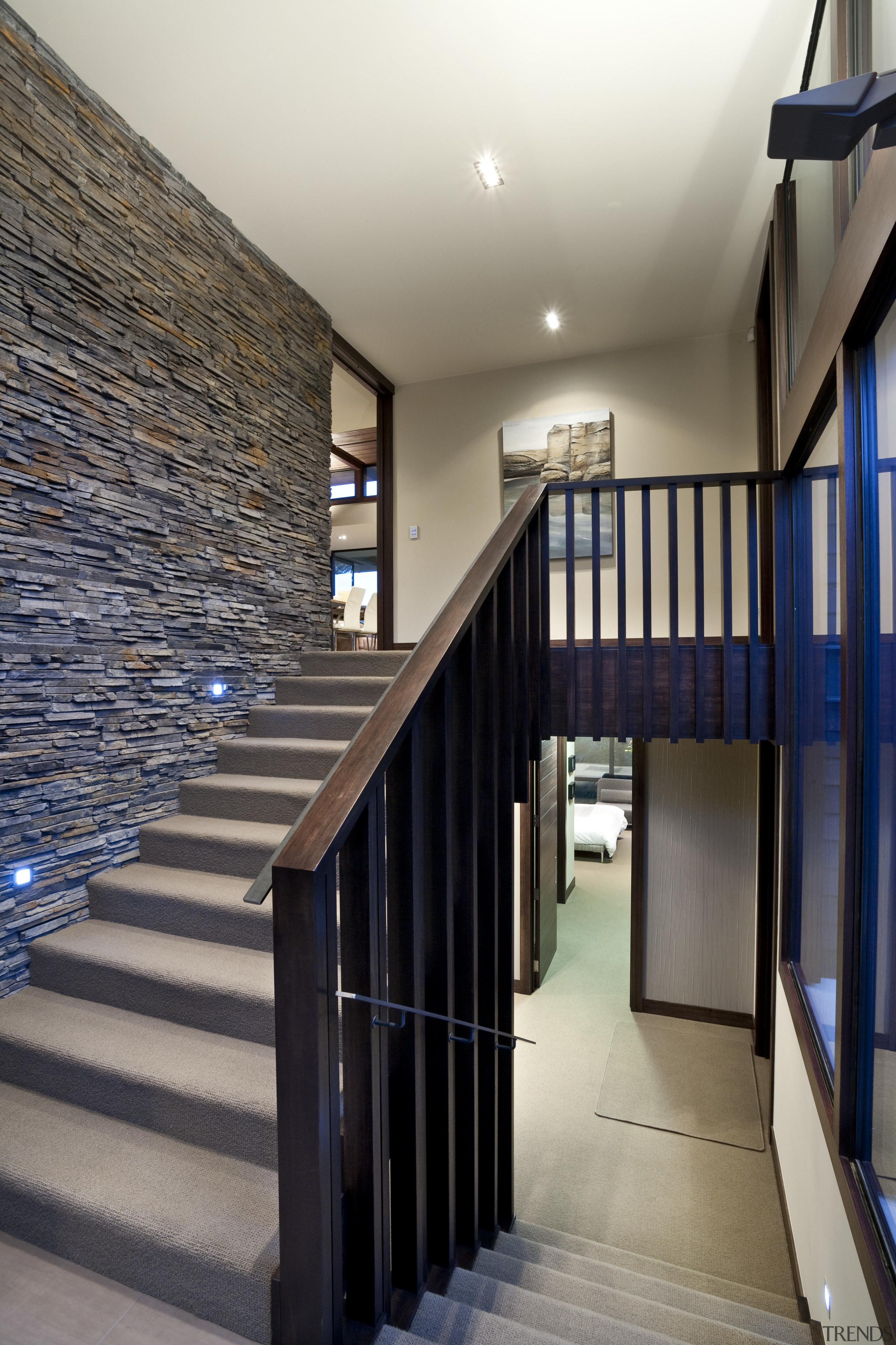 View of stairway which features schist stone wall, architecture, building, daylighting, handrail, house, interior design, real estate, stairs, wood, gray, black