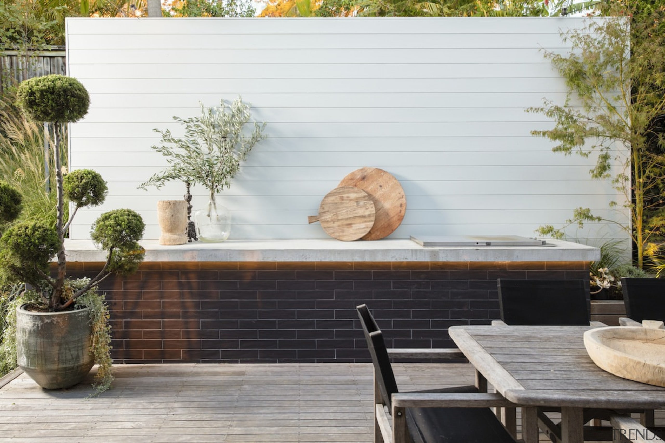 You might look to introduce some enclosed walls backyard, flooring, furniture, home, outdoor structure, patio, plant, table, wall, wood, white