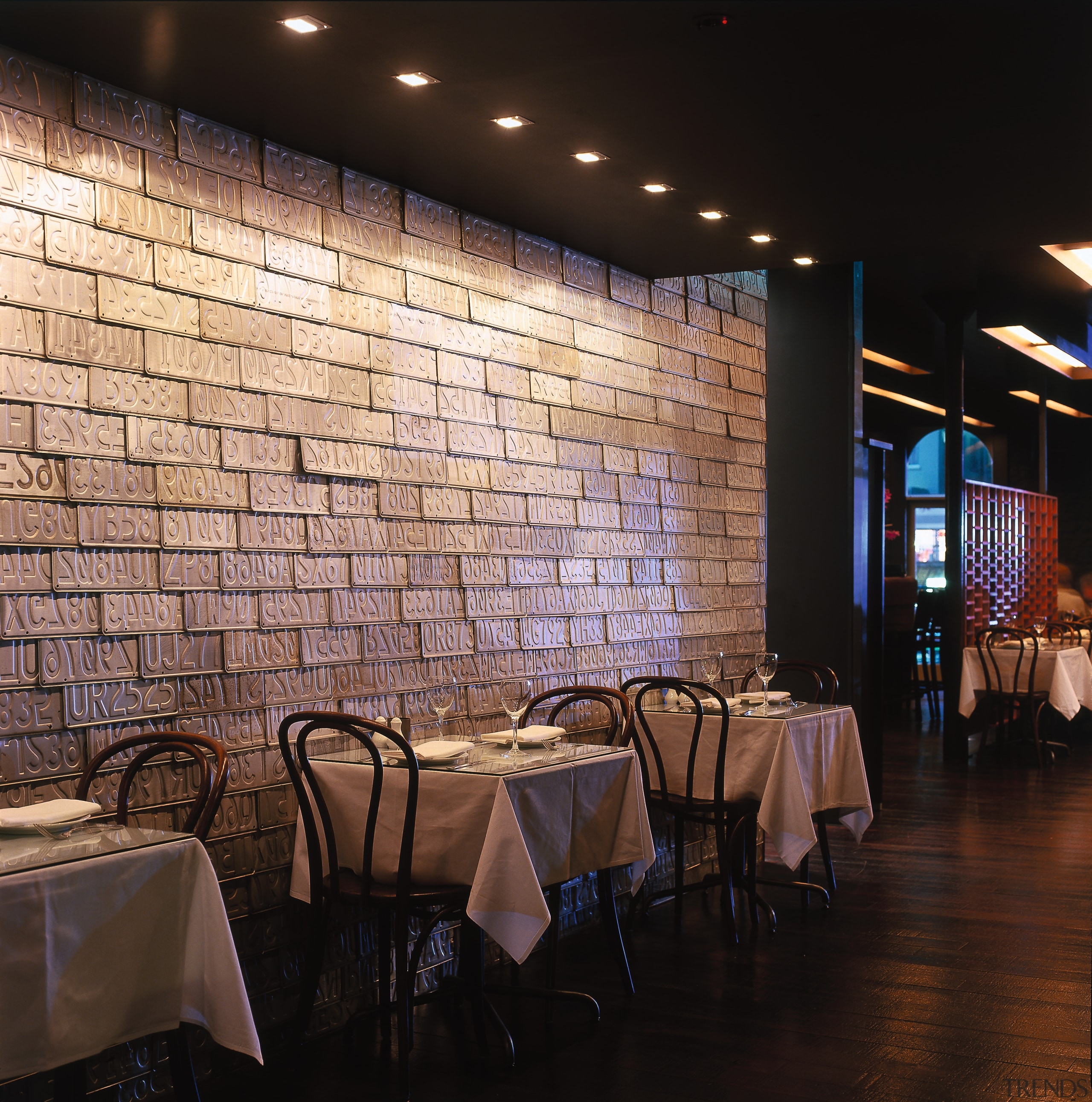 Restaurant with tables and chairs along feature wall ceiling, interior design, lighting, restaurant, table, wall, black