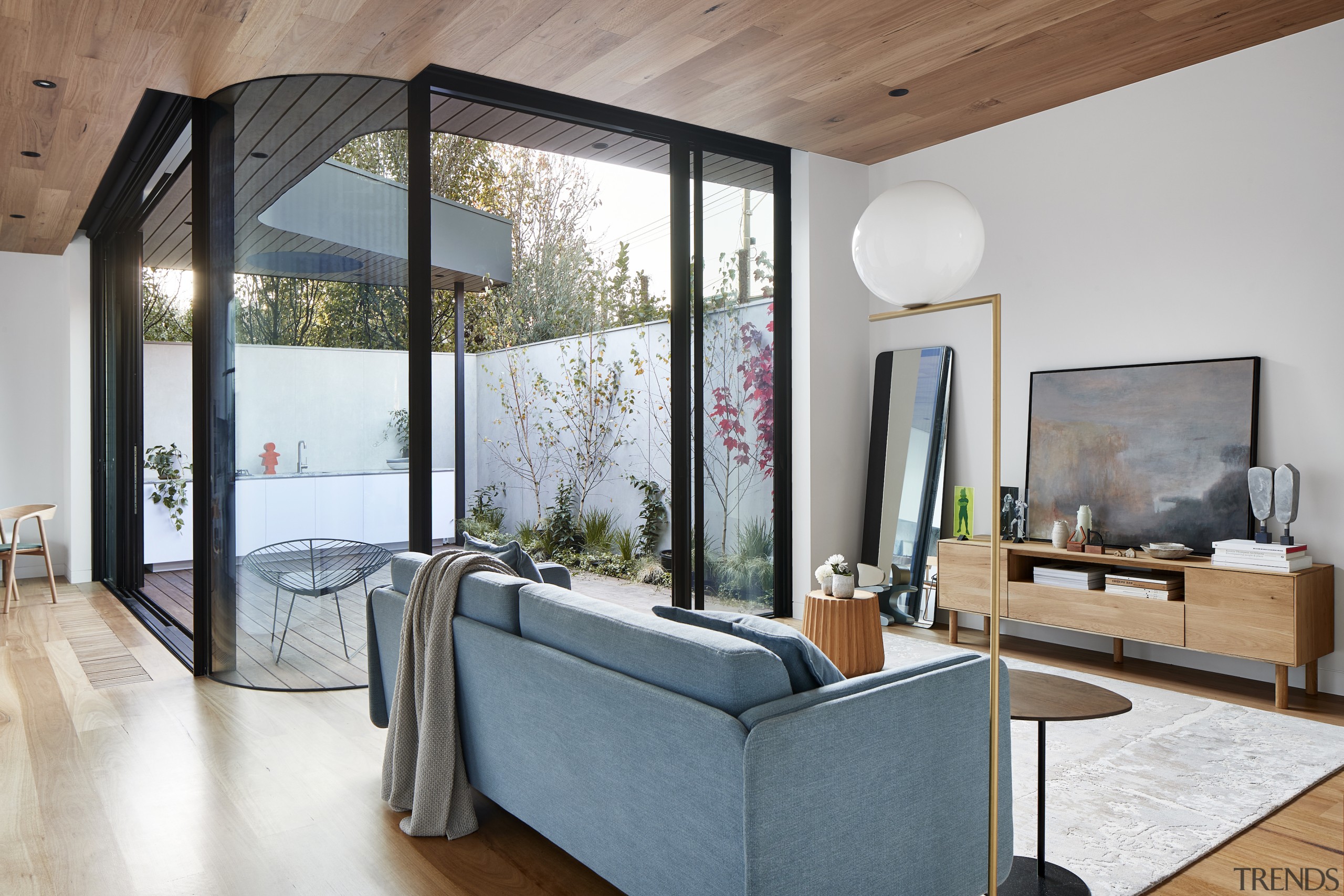 Timber floor and ceiling bookend the white interior. 