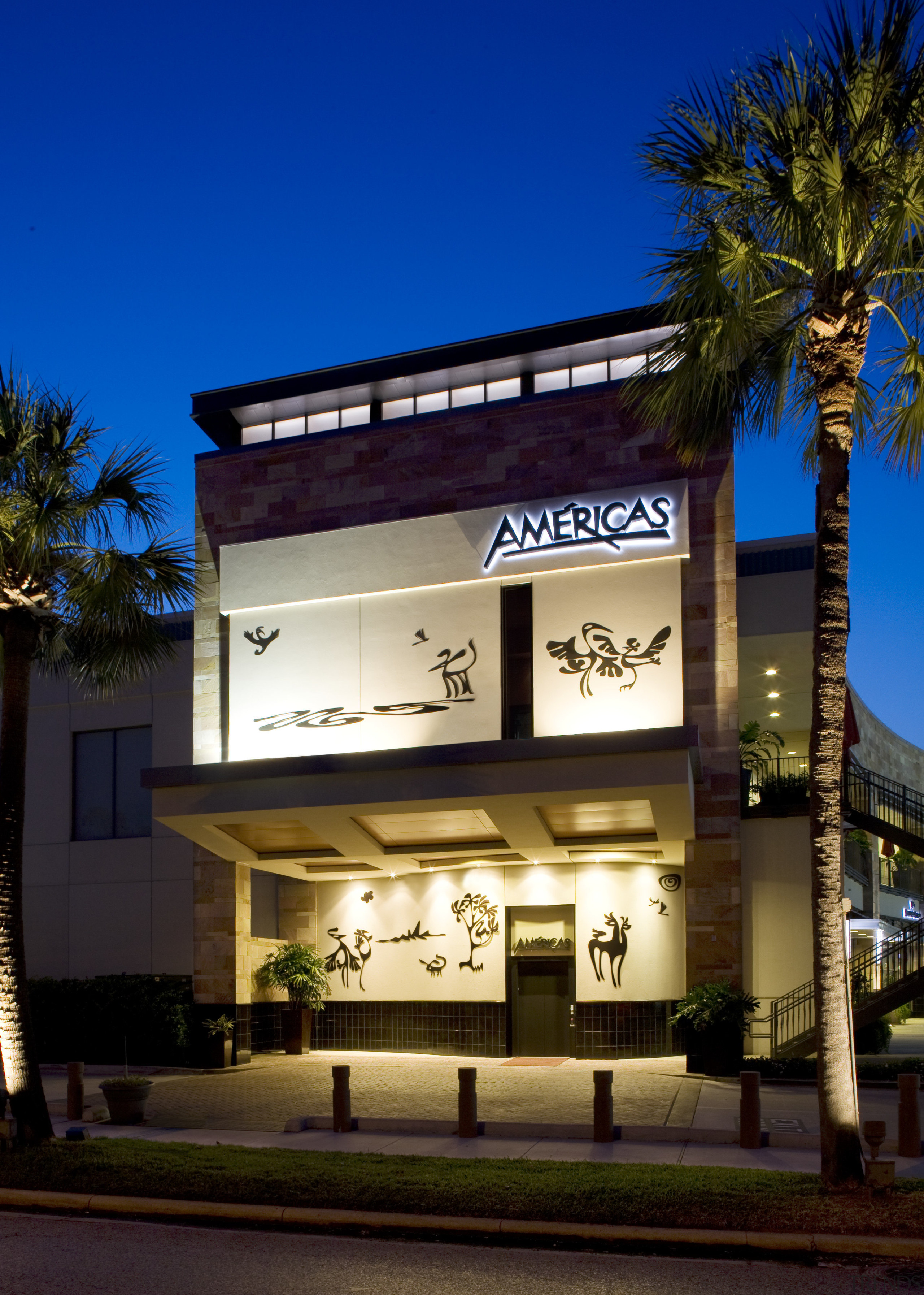 The facade of the Américas River Oaks restaurant architecture, building, commercial building, facade, home, hotel, mixed use, night, real estate, residential area, sky, black, blue
