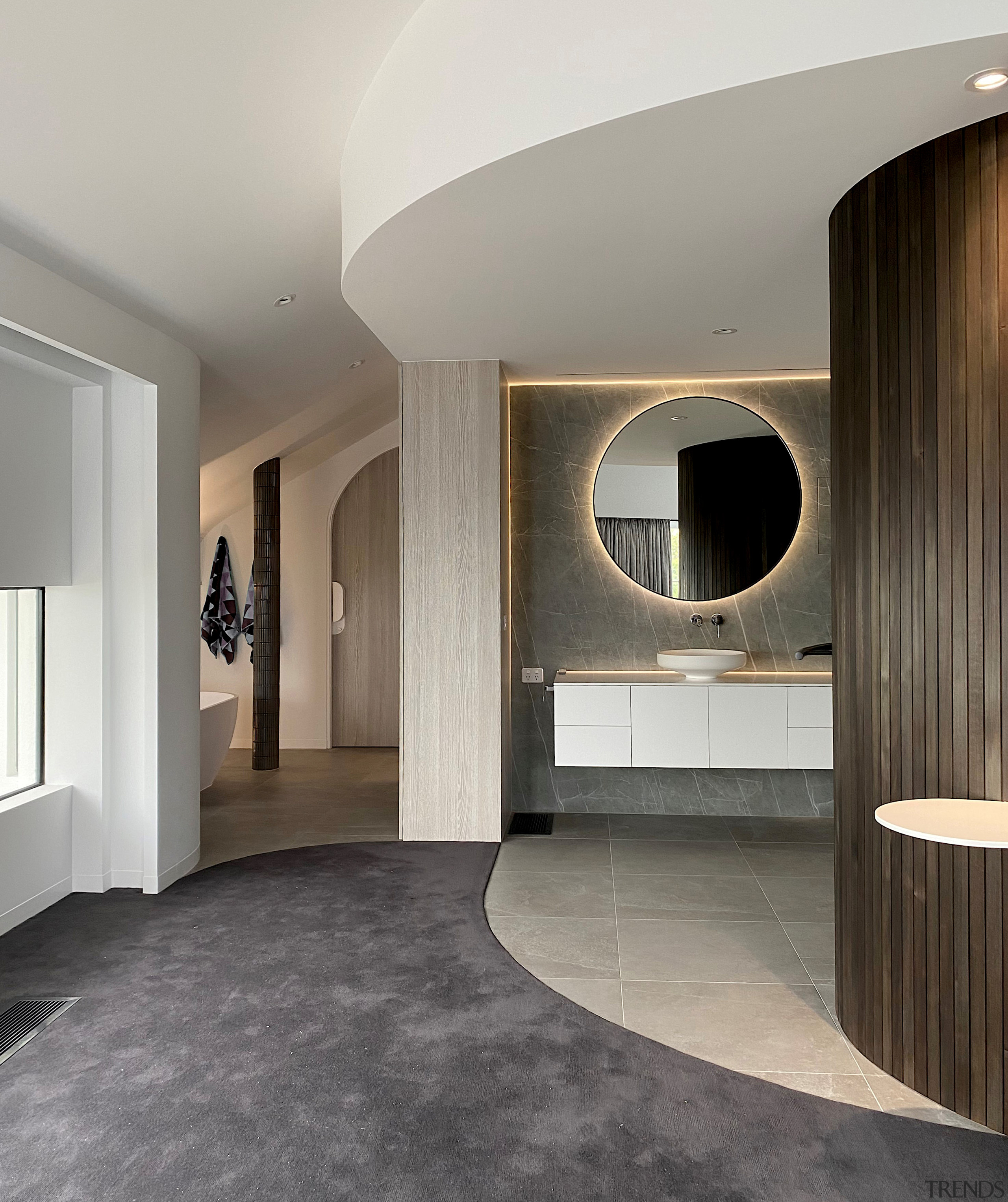 Recessed lighting highlights the floating vanity and feature 