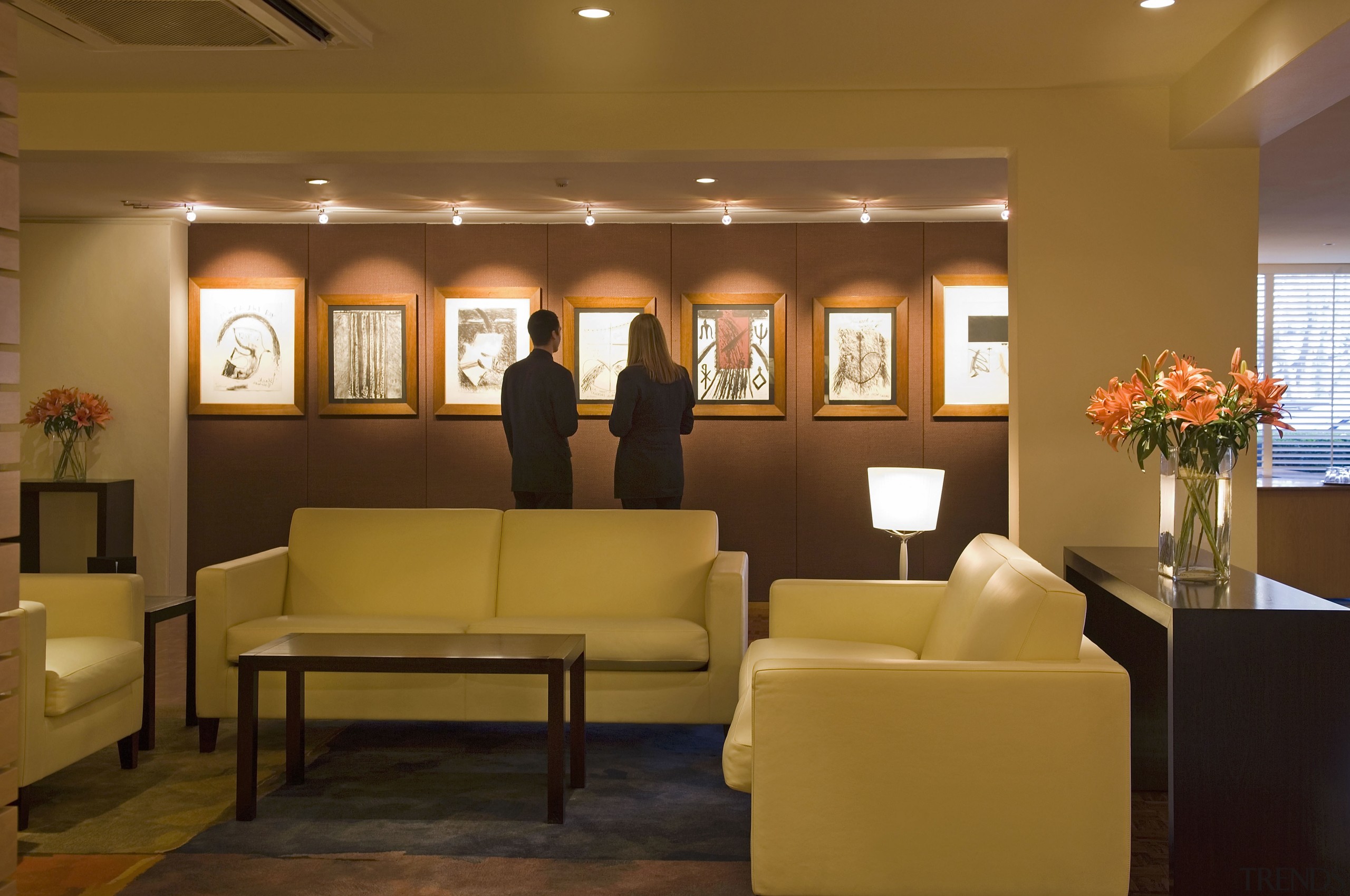 A view of the hotel lobby featuring parquet ceiling, furniture, interior design, living room, lobby, room, waiting room, brown