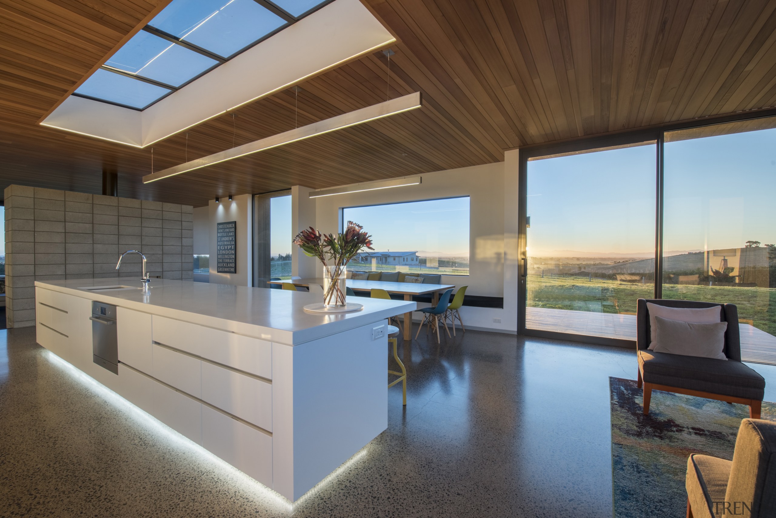 The kitchen island and dining table are positioned apartment, architecture, ceiling, daylighting, estate, home, house, interior design, real estate, brown