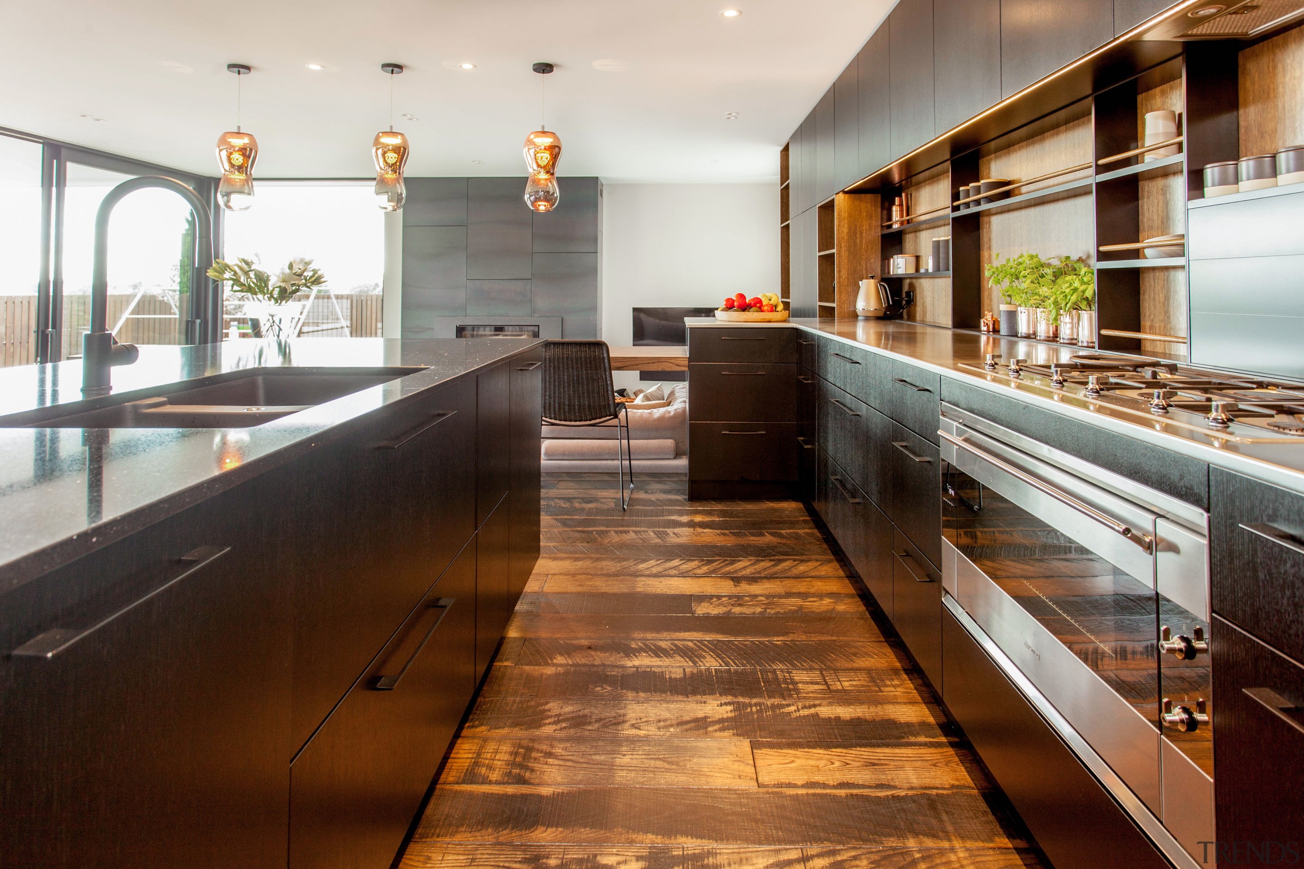 In this clean-lined kitchen, a Smeg rangehood is countertop, interior design, kitchen, real estate, wood, brown, white