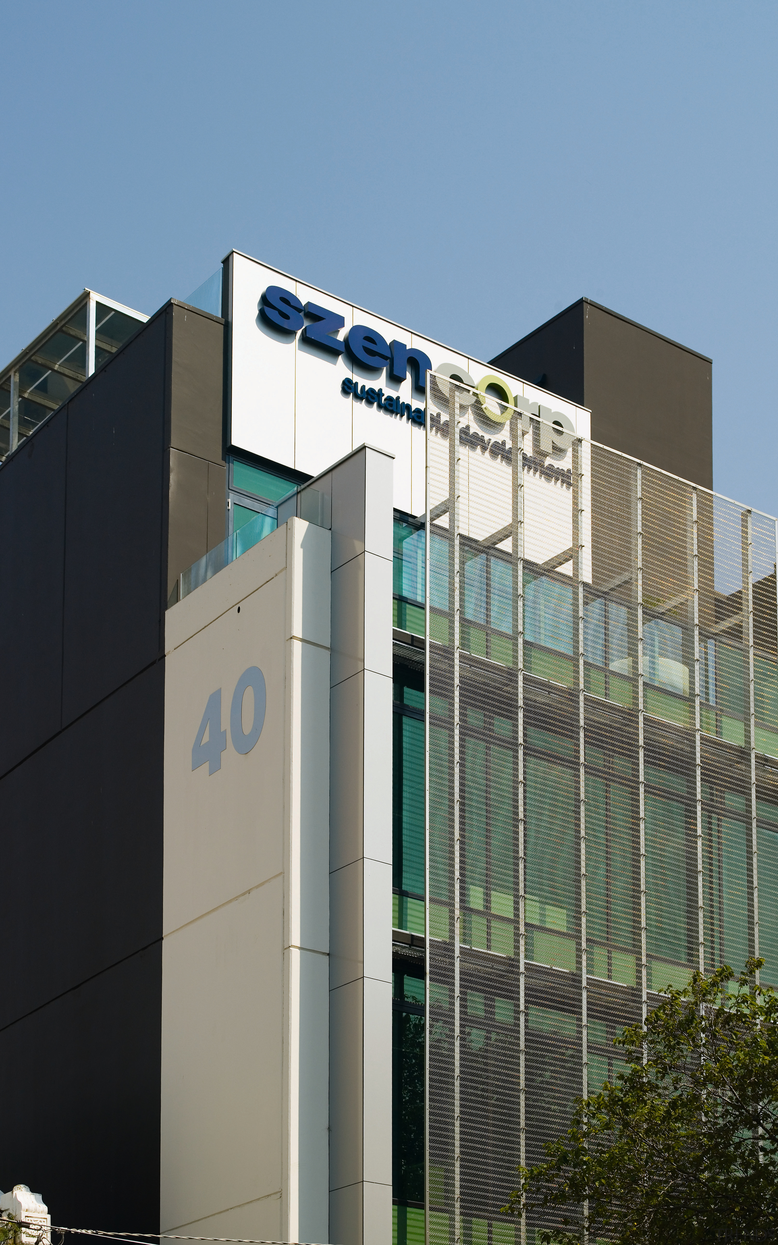 A view of  the Szencorp offices in architecture, building, corporate headquarters, facade, fence, headquarters, metropolitan area, residential area, teal