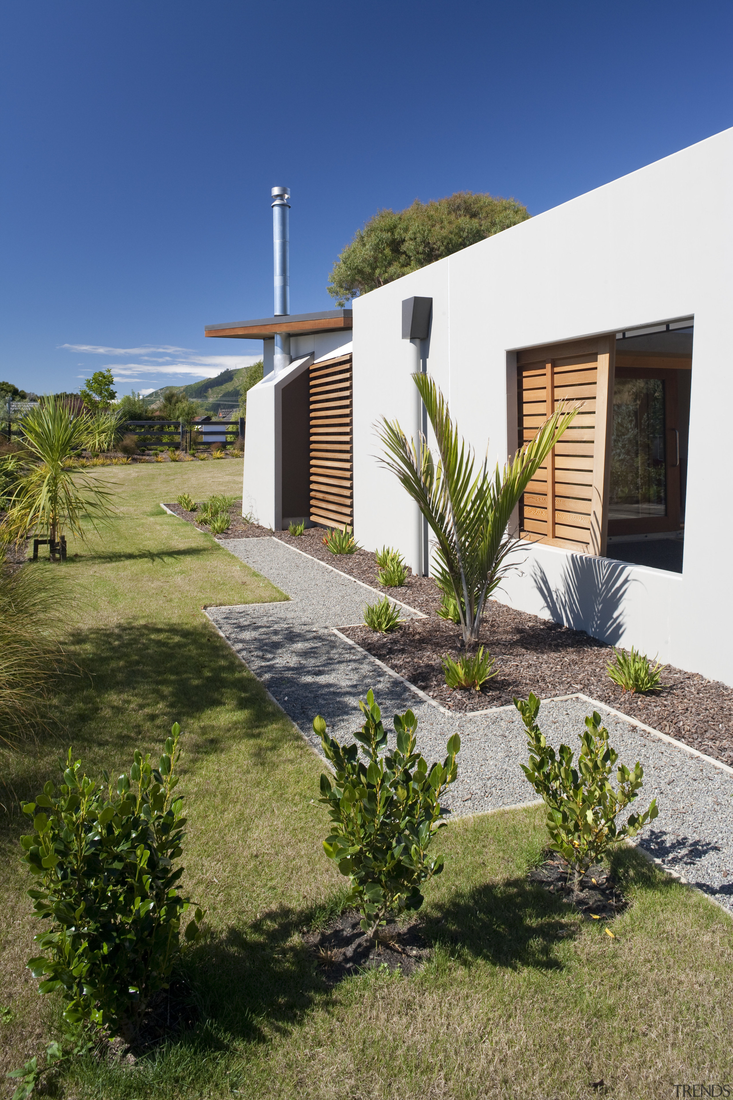 Exterior view of an energy-efficient home and gardens architecture, cottage, estate, facade, home, house, landscape, landscaping, property, real estate, residential area, villa, yard, brown