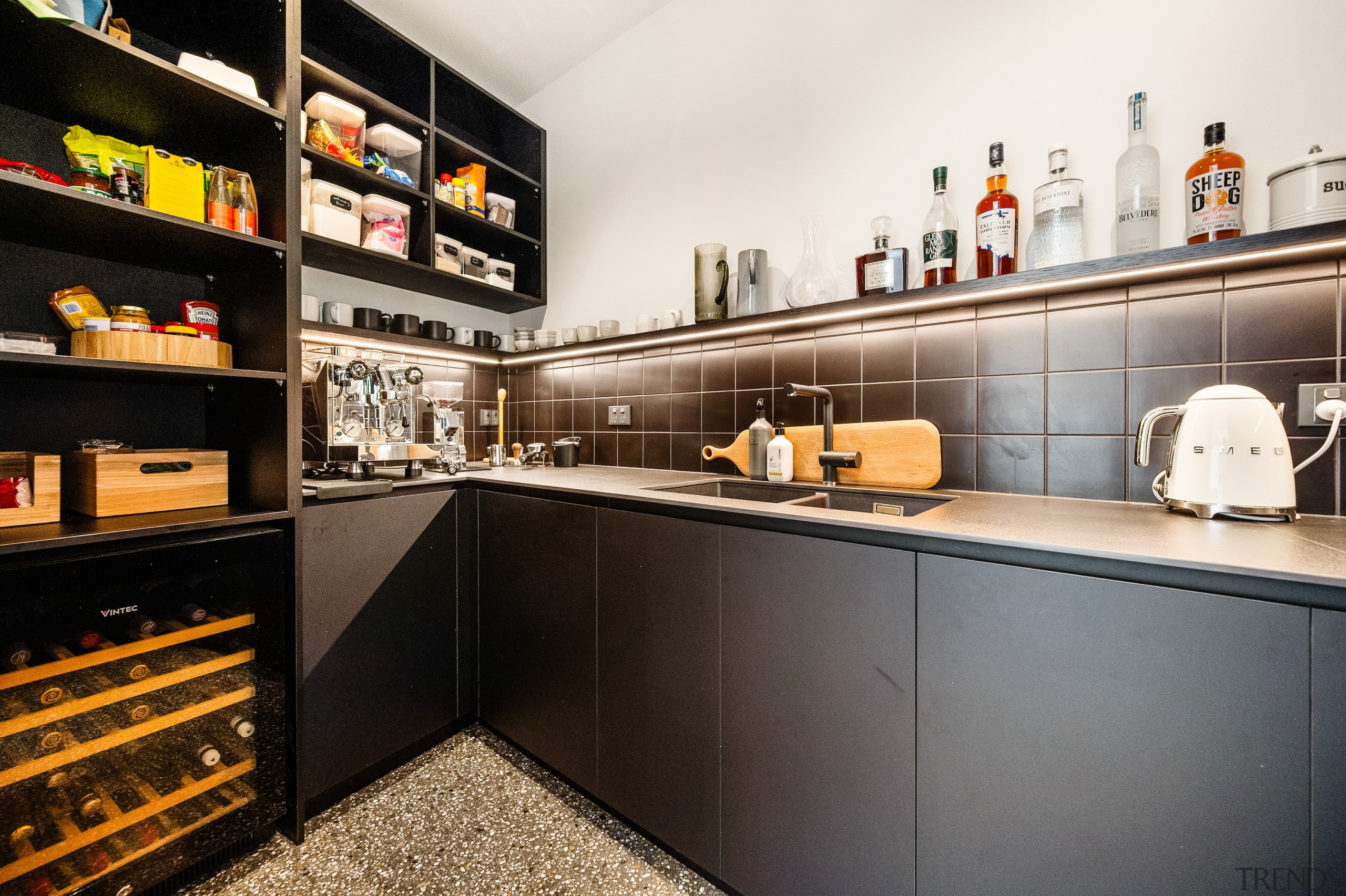 Scullery with ample cabinetry and display storage. 