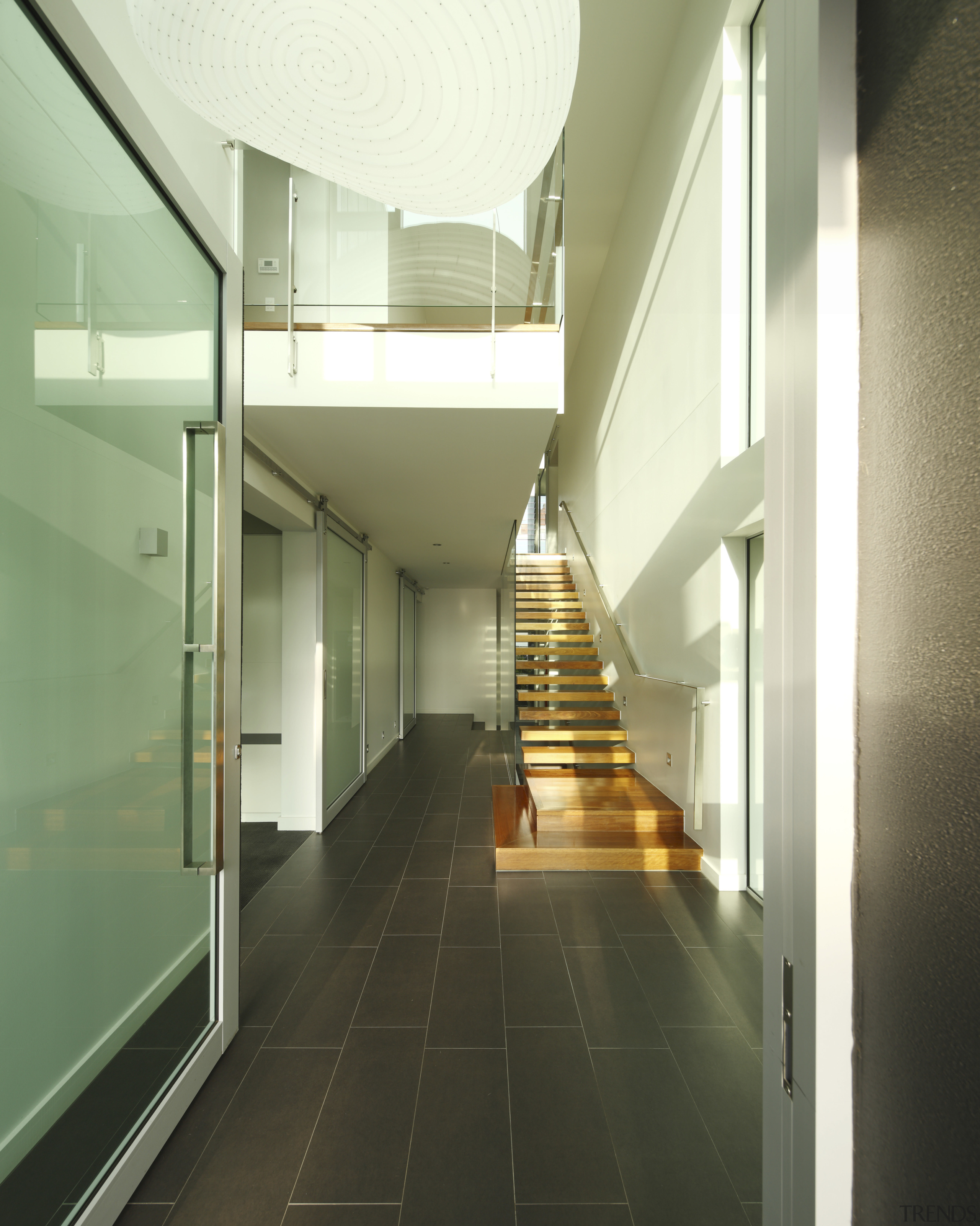 Hallway shot with stairs. - Hallway shot with architecture, ceiling, daylighting, floor, glass, handrail, house, interior design, lobby, stairs, green