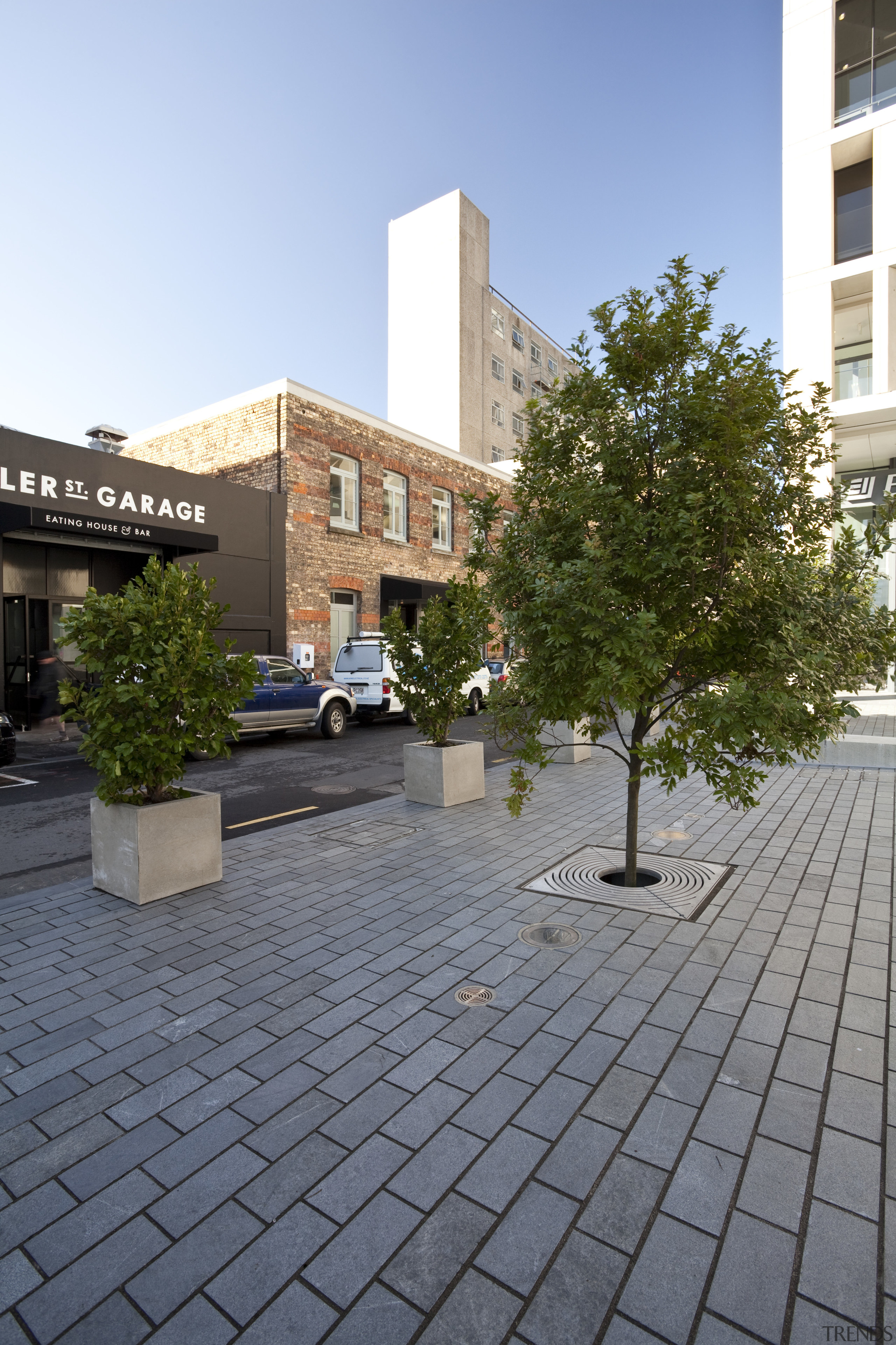 View of the public square at the Britomart apartment, architecture, building, campus, city, condominium, courtyard, daytime, estate, facade, house, mixed use, neighbourhood, public space, real estate, residential area, road surface, roof, sky, tree, urban area, walkway, gray