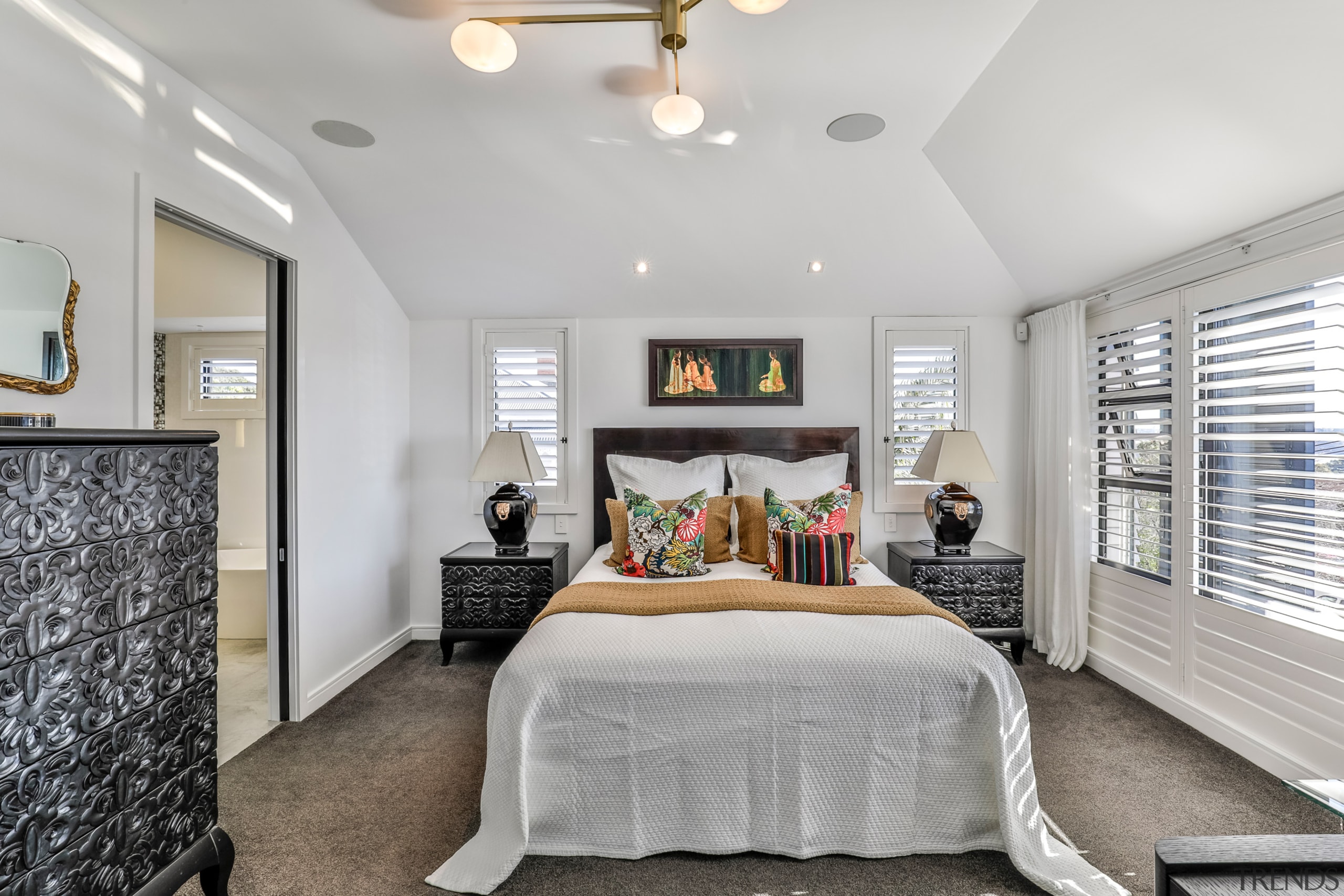 The now, white, high-ceilinged master bedroom. 