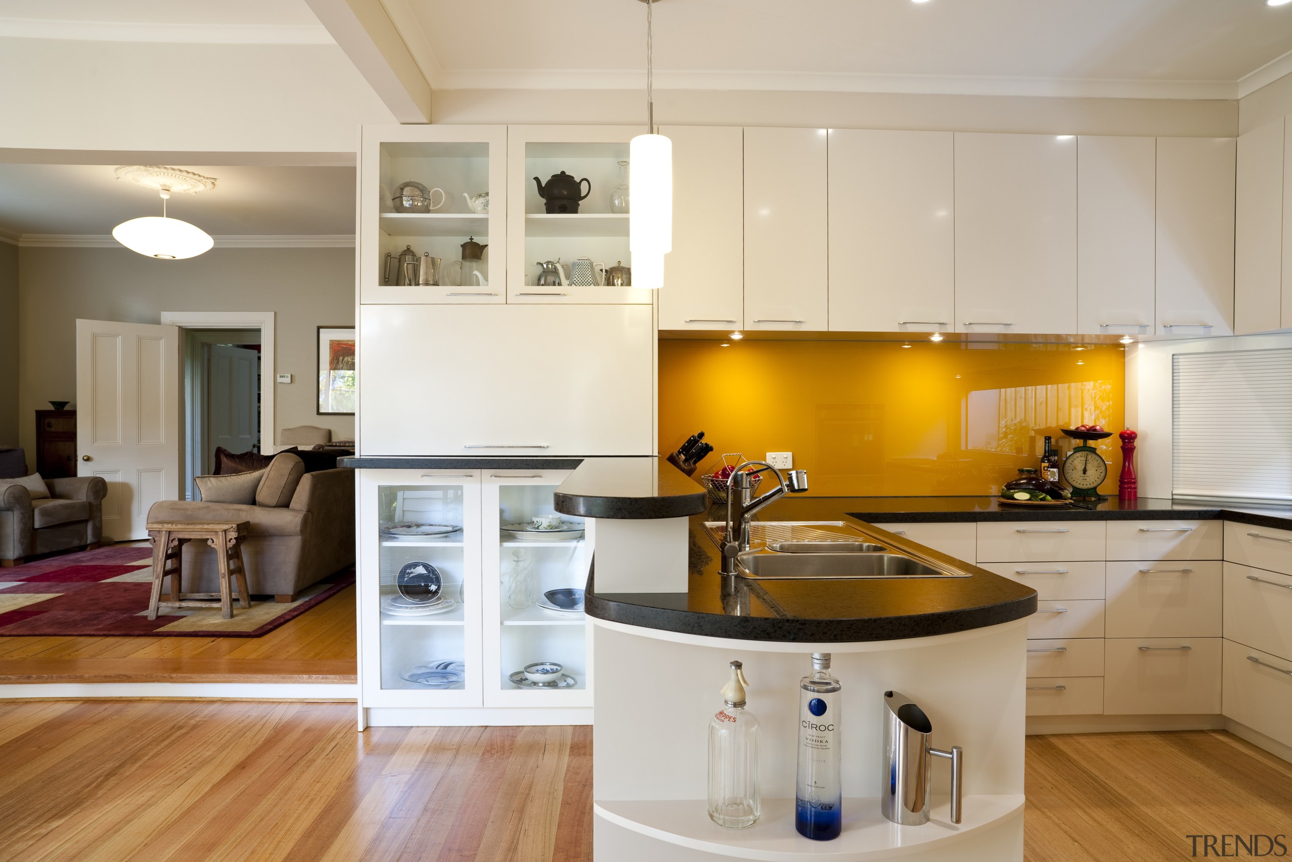 View of contemporary kitchen with white cabinetry, island cabinetry, countertop, cuisine classique, floor, hardwood, home, interior design, kitchen, real estate, room, wood flooring, gray