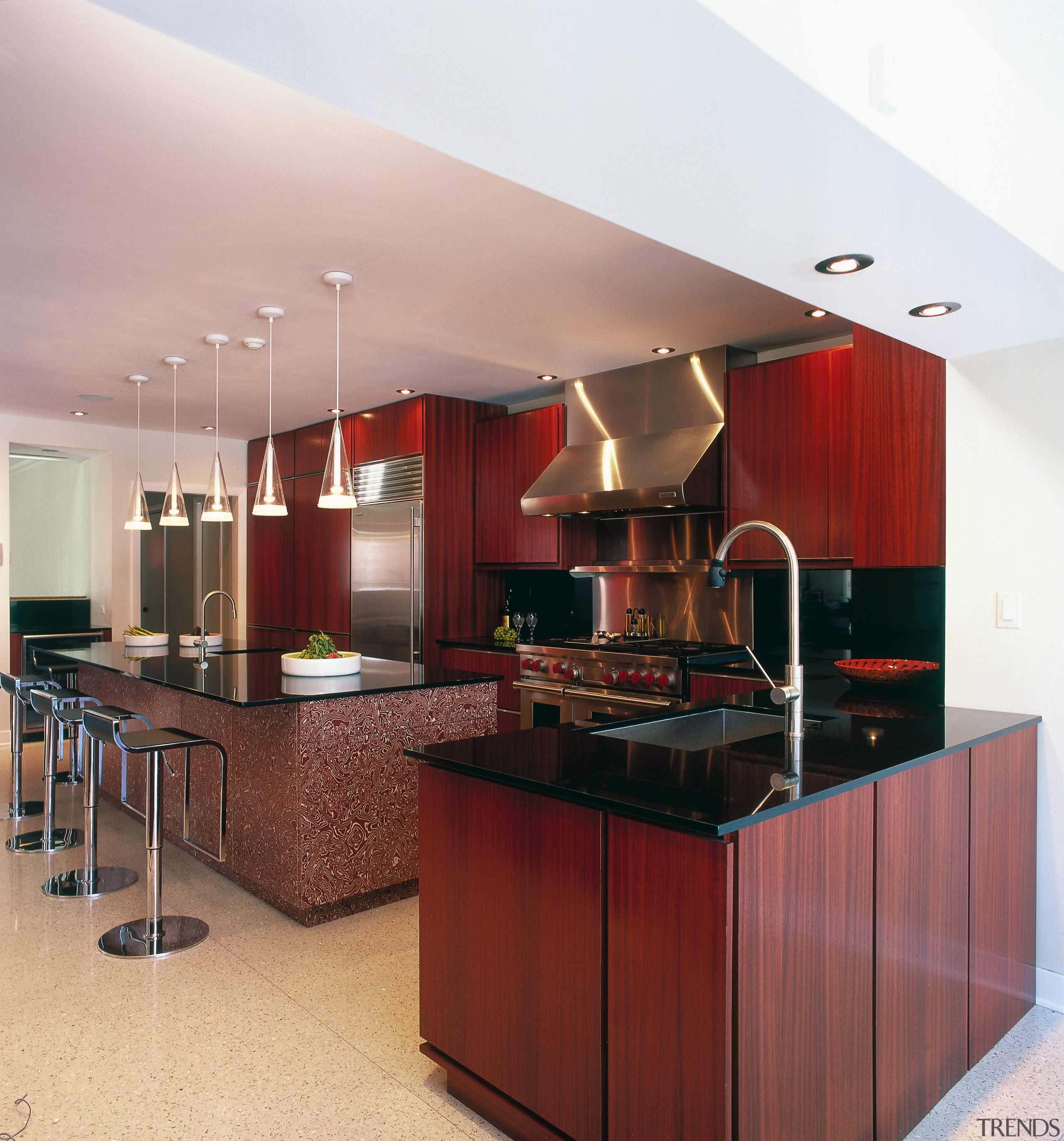 A view of this kitchen featuring terrazzo flooring, cabinetry, ceiling, countertop, cuisine classique, interior design, kitchen, red