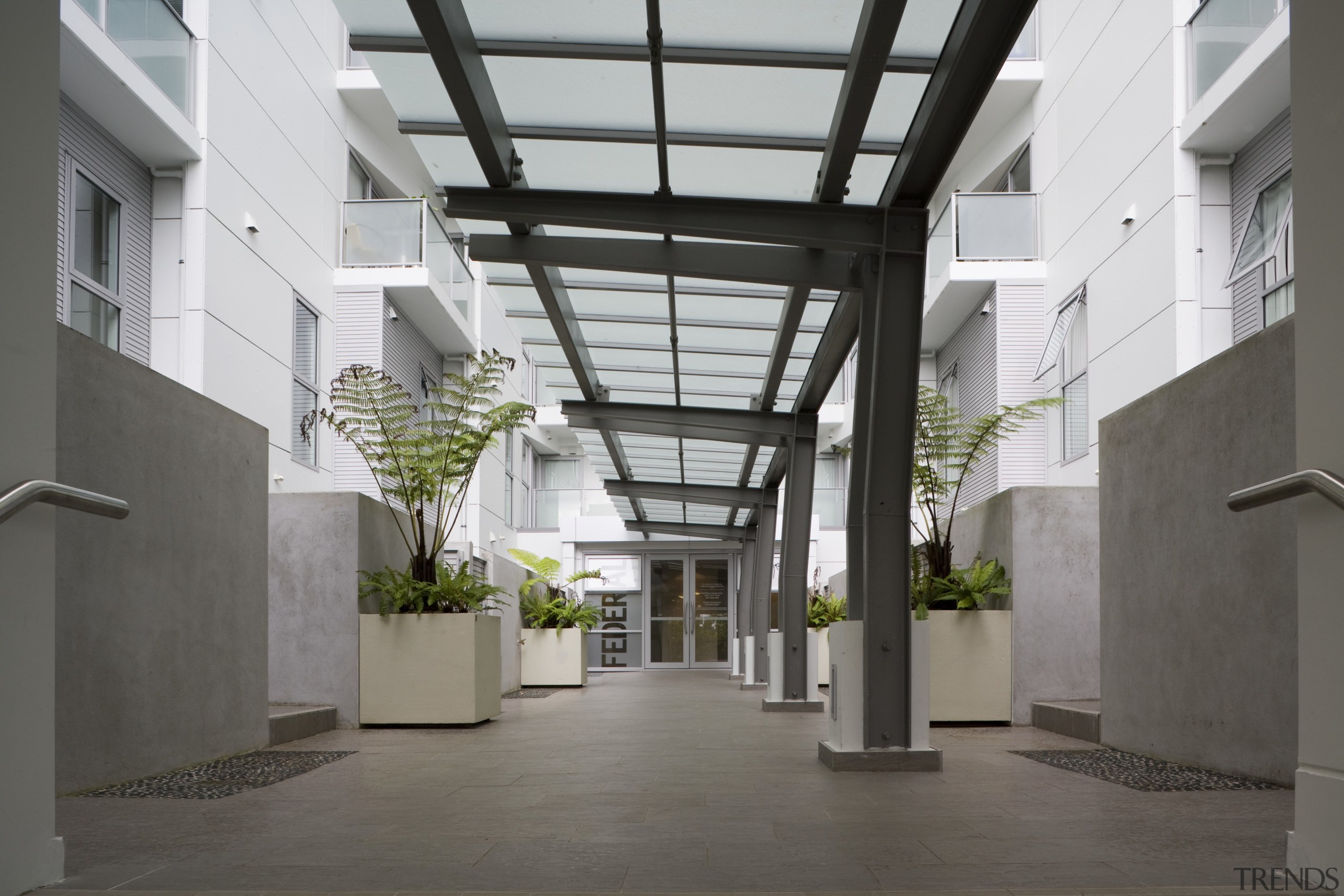 View of a two-storey maisonette which lines the building, condominium, courtyard, daylighting, lobby, gray