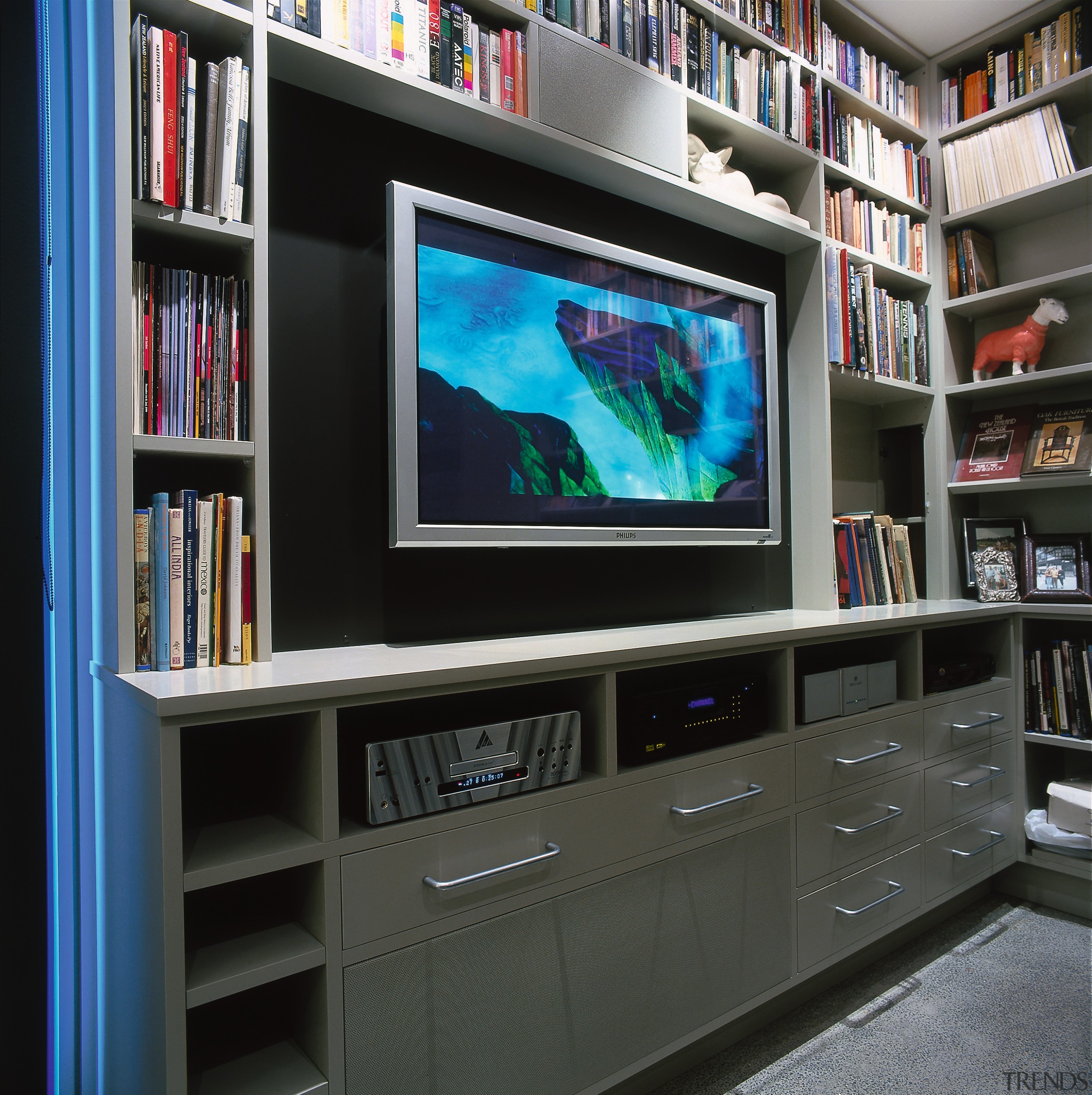 Home theatre componetry siting on built-in shelves below bookcase, display device, electronics, entertainment center, flat panel display, furniture, library, multimedia, screen, shelf, shelving, technology, television, black