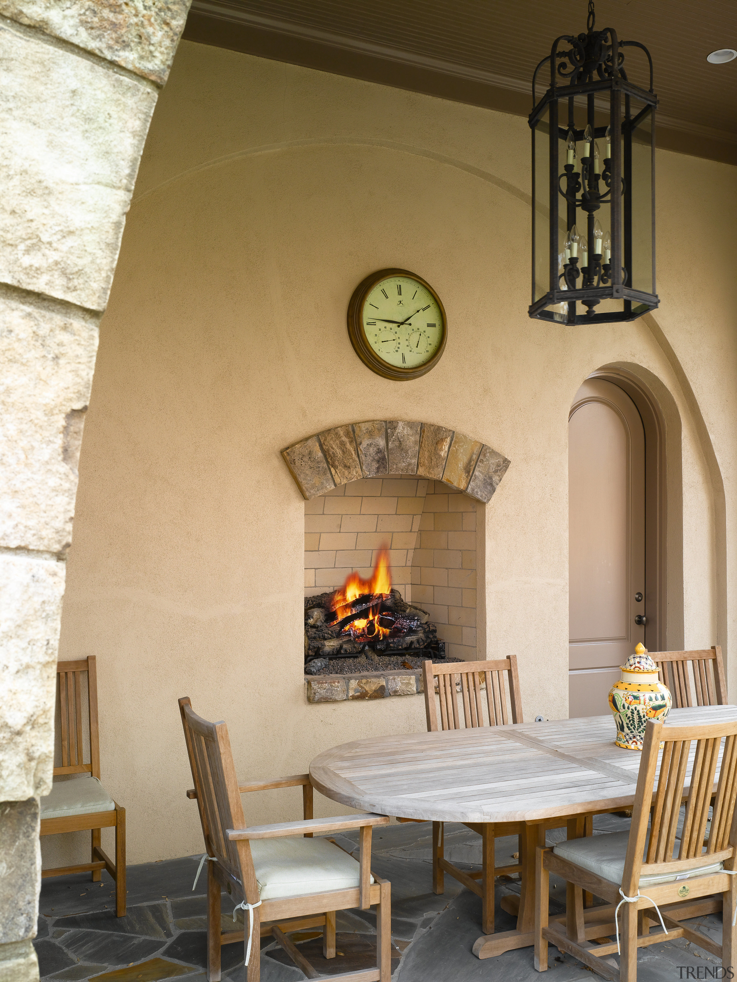 View of outdoor fireplace setting, with dining chair ceiling, fireplace, furniture, hearth, home, interior design, living room, table, wall, brown