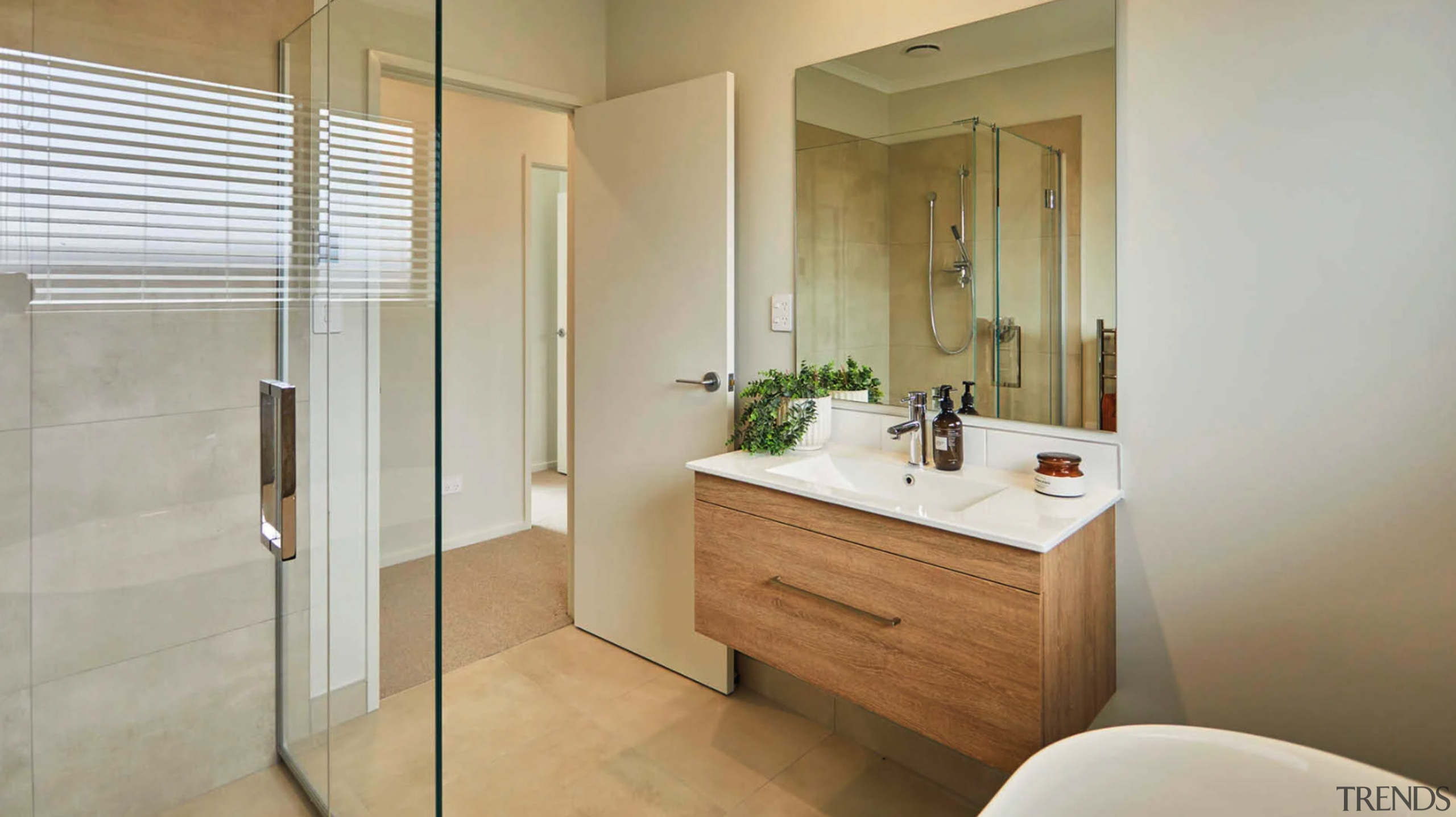 Light-filled and roomy main bathroom with cantilevered wood 