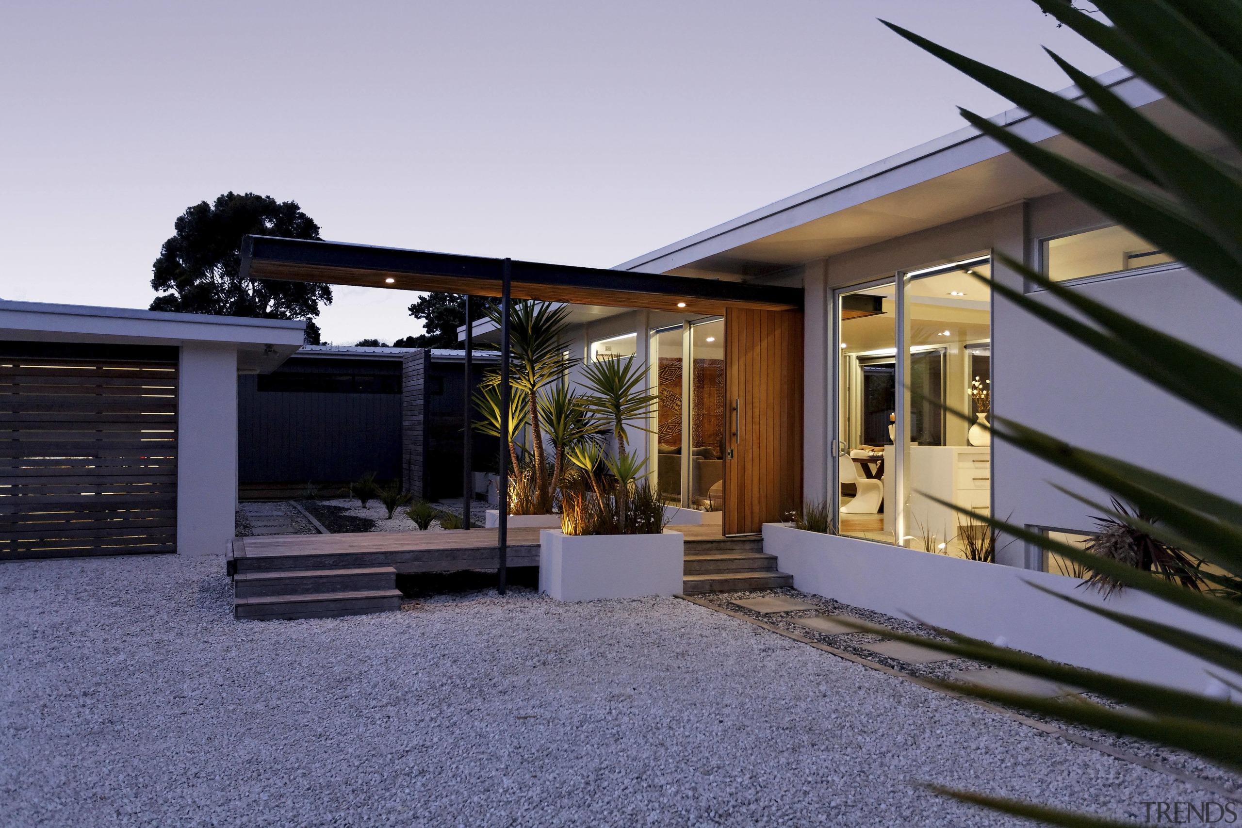 Exterior view of the entrance way of this architecture, estate, facade, home, house, outdoor structure, property, real estate, residential area, window, gray