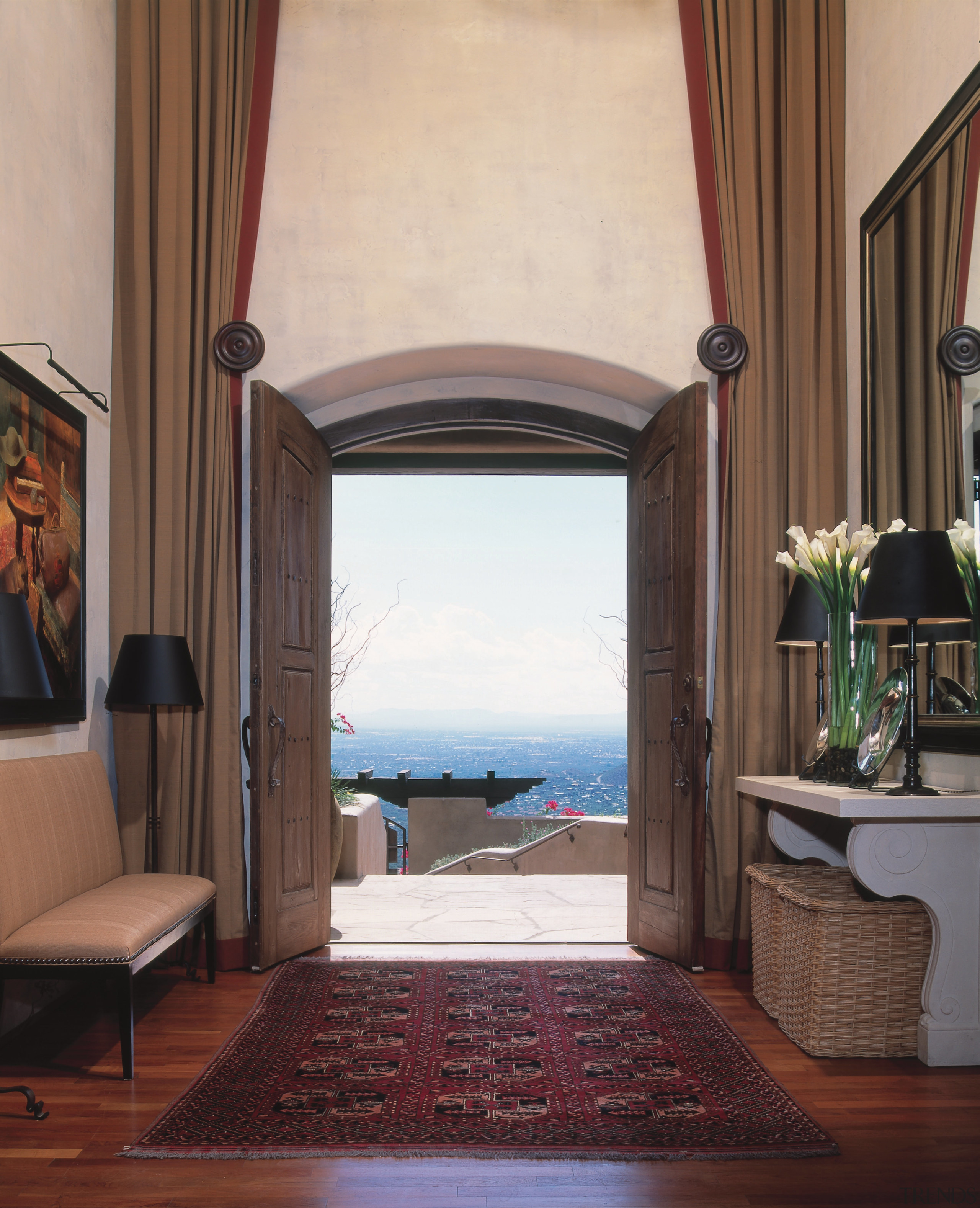 A view of the double height foyer in architecture, ceiling, door, estate, floor, flooring, furniture, home, interior design, living room, property, real estate, room, wall, window, window treatment, wood, gray, brown