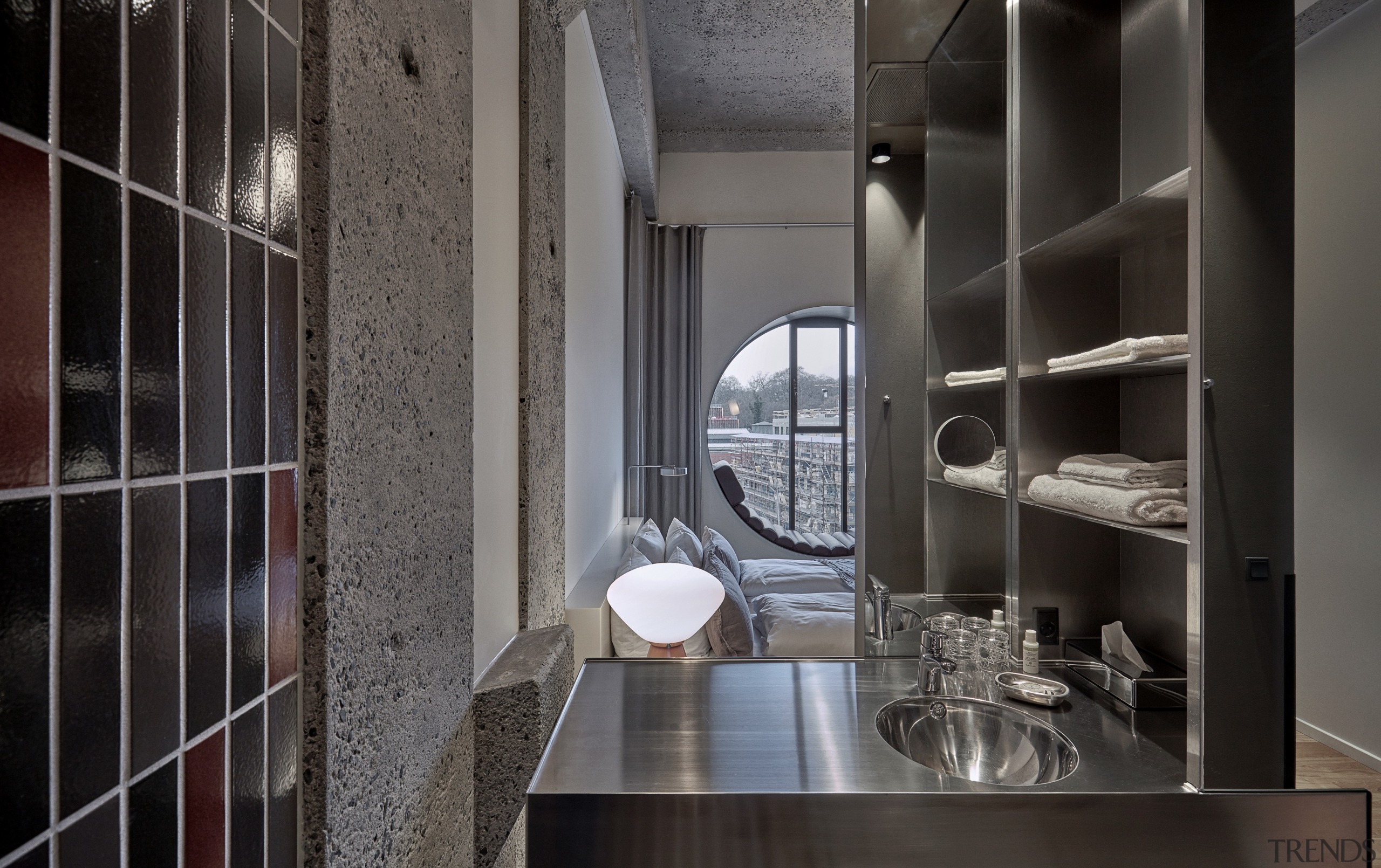 Exposed concrete surfaces contribute to the hotel's industrial-chic architecture, building, cabinetry, cupboard, furniture, house, interior design, loft, property, room, shelf, shelving, tile, black, gray