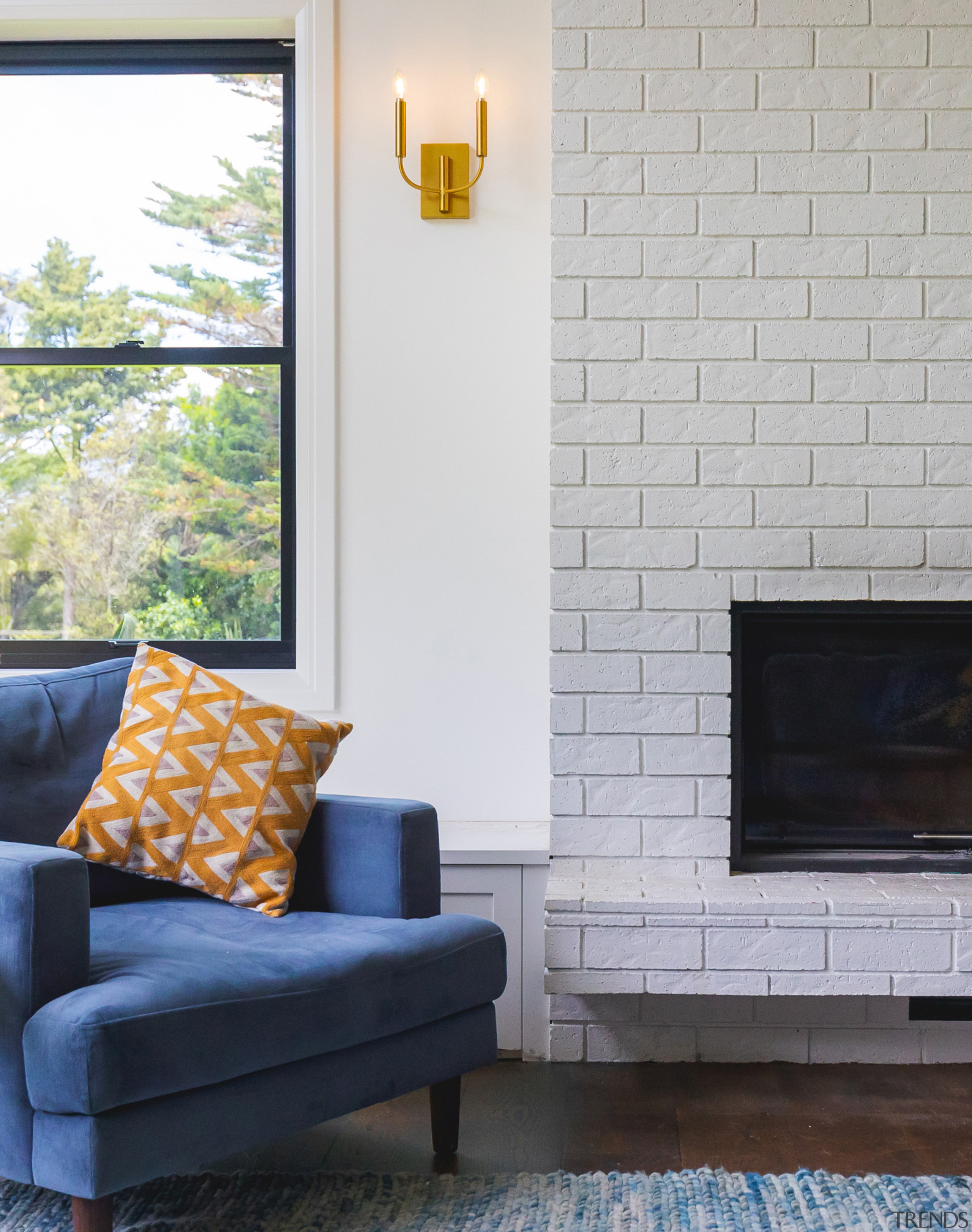 A traditional brick fireplace anchors the centre of 