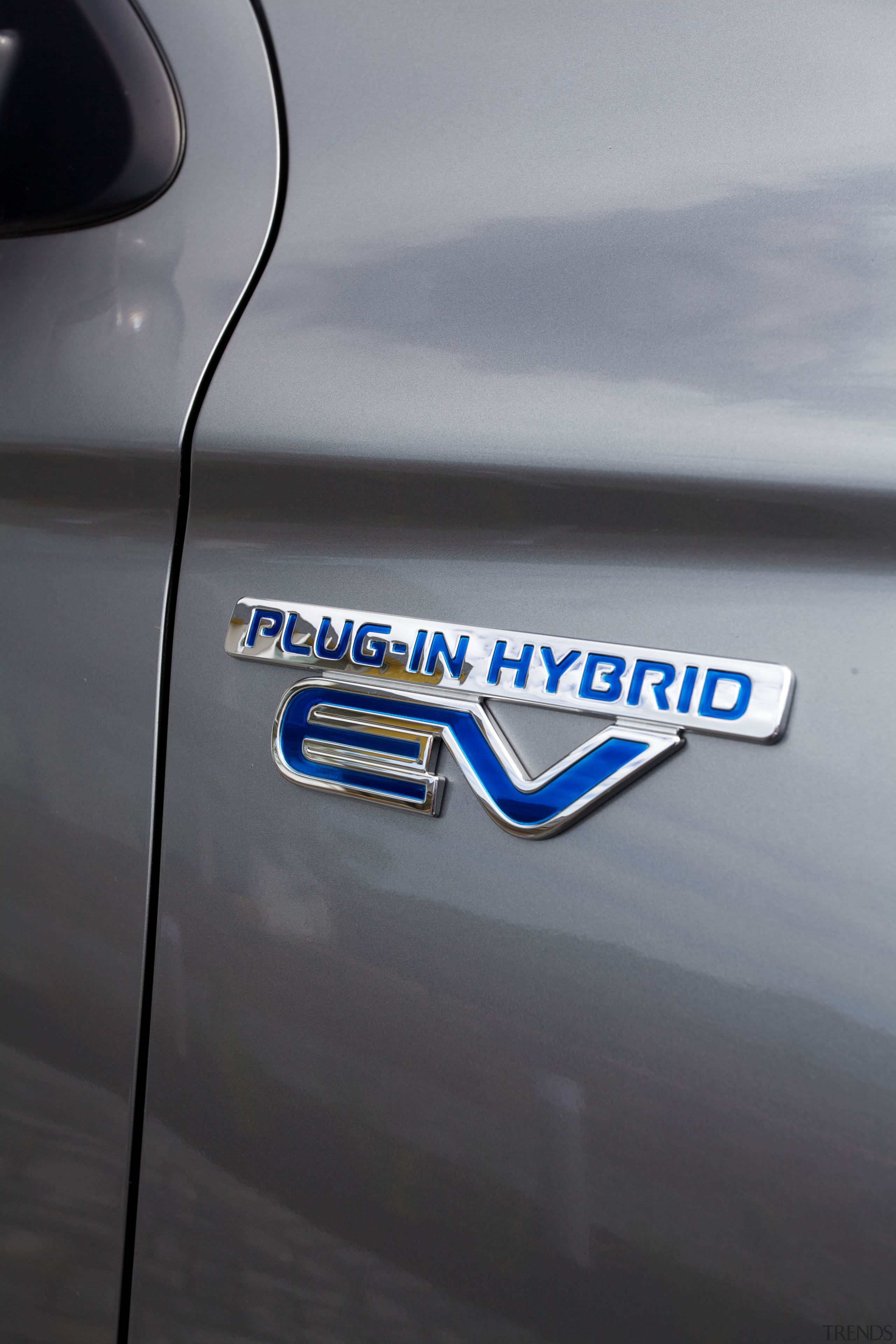 The Mitsubishi Outlander Plug-In Hybrid SUV is powered automotive design, automotive exterior, automotive lighting, blue, car, family car, font, graphics, logo, mode of transport, motor vehicle, personal luxury car, vehicle, vehicle door, gray, black