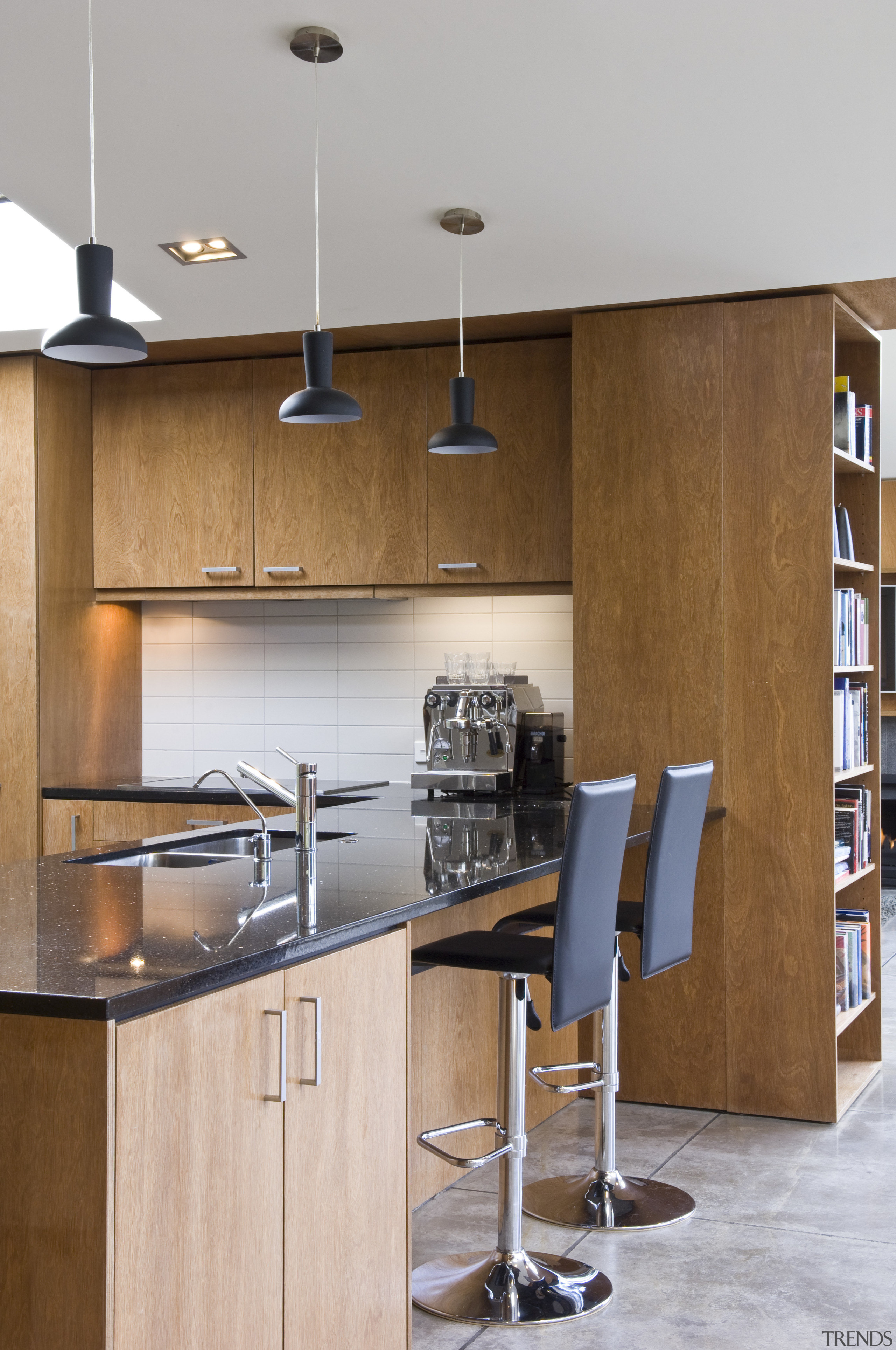 View of a kitchen featuring black granite benchtops, cabinetry, countertop, cuisine classique, furniture, interior design, kitchen, product design, shelf, shelving, wall, gray, brown