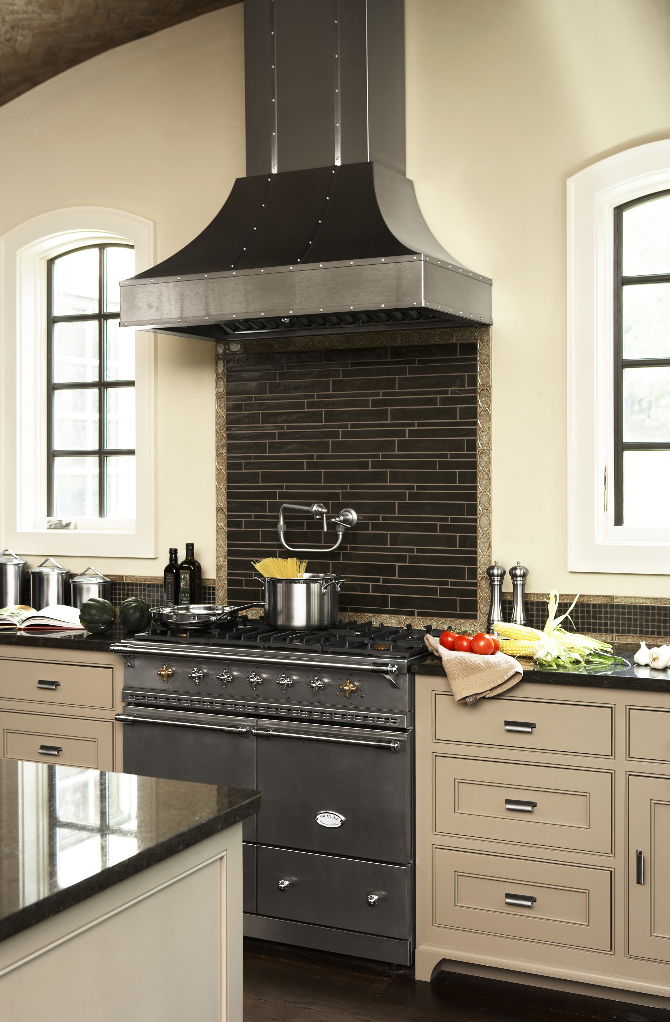 View of hand-built Lacanche French ranges offered by cabinetry, countertop, cuisine classique, home appliance, interior design, kitchen, kitchen appliance, kitchen stove, room, black, yellow