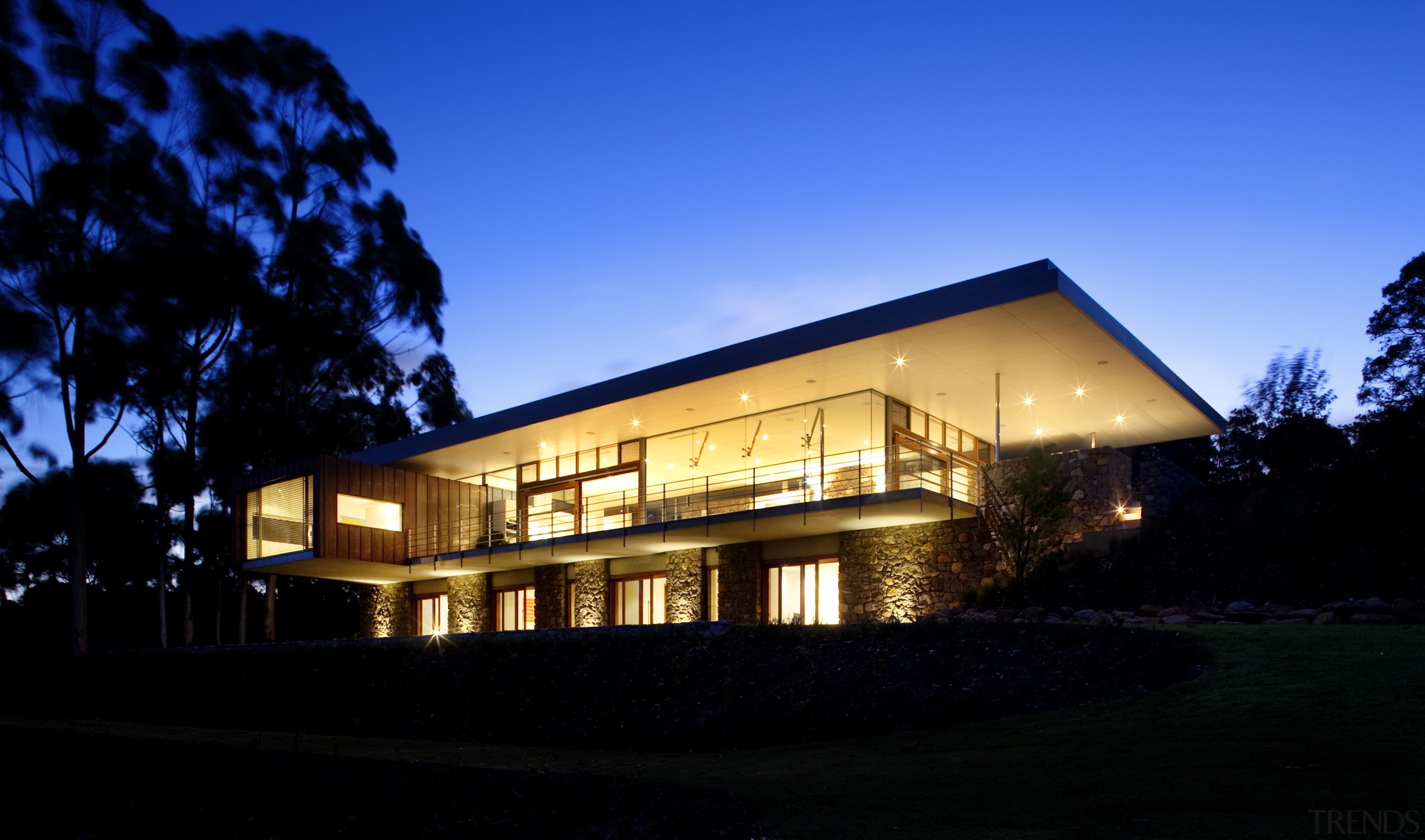 This house was designed by Tim Wright AIA architecture, building, cottage, estate, evening, facade, home, house, lighting, night, property, real estate, residential area, sky, black