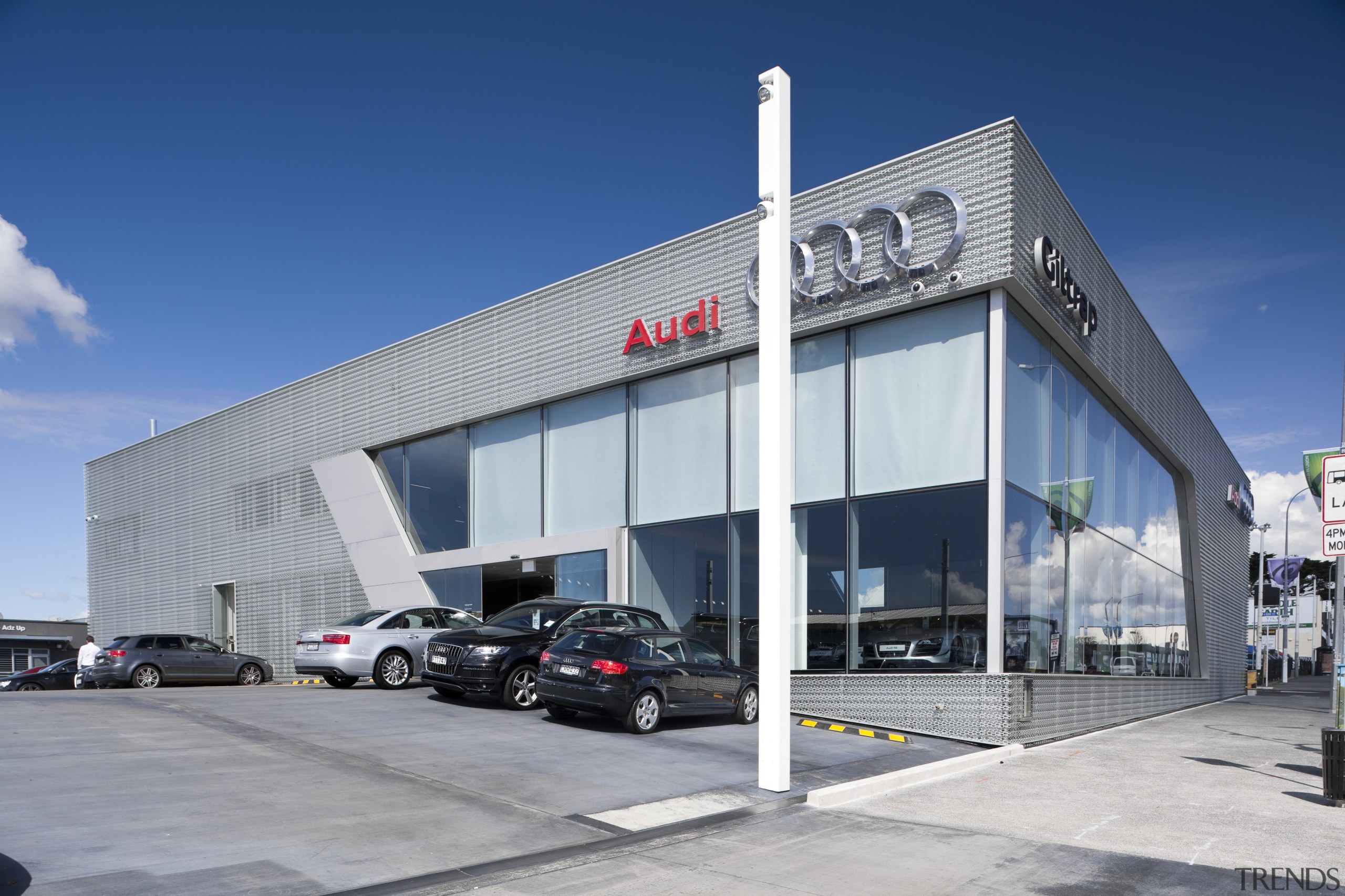 The aluminum facade and metal work was done building, car dealership, commercial building, corporate headquarters, facade, real estate, gray, blue