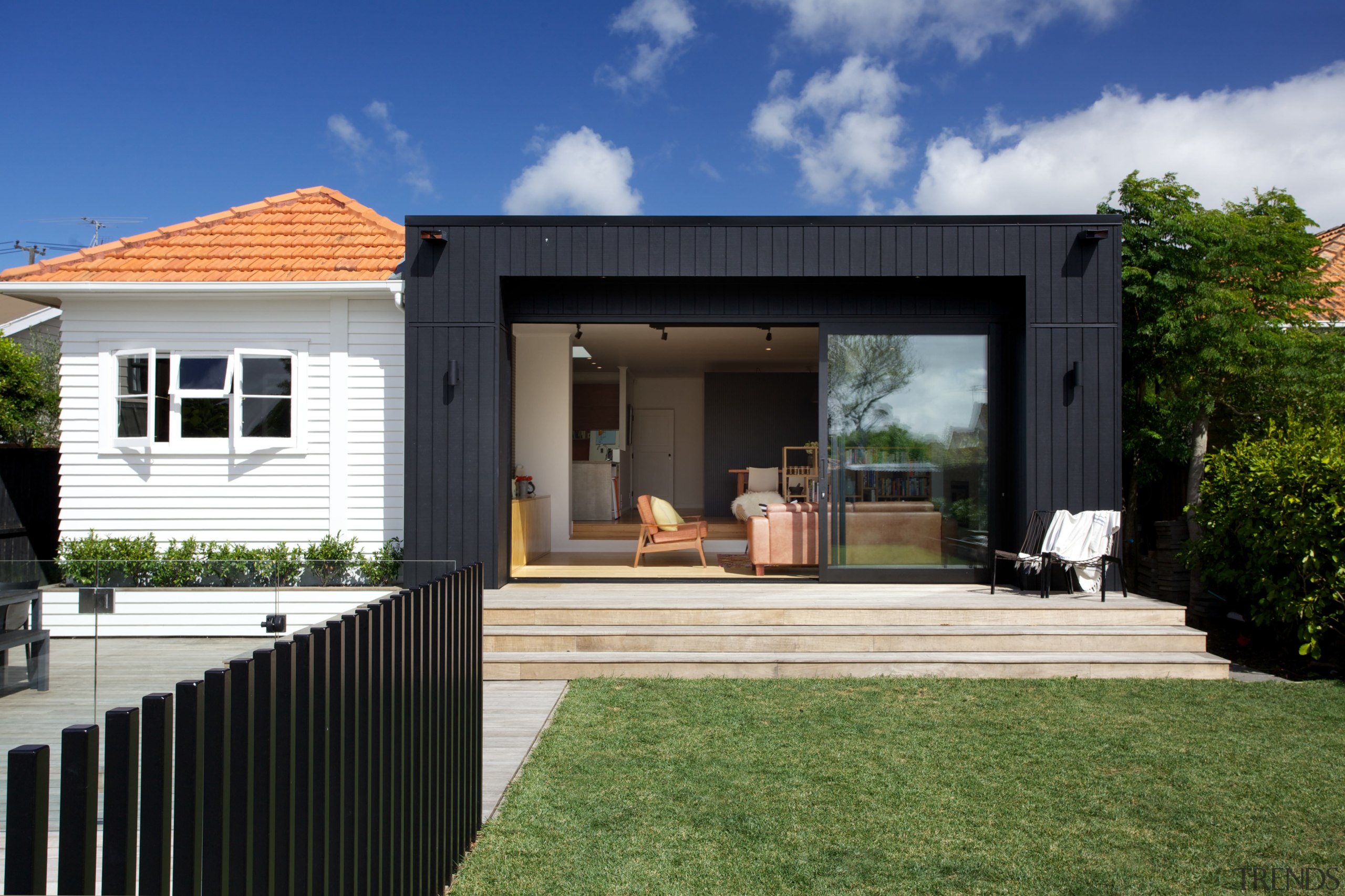 Contemporary black box addition to older home the backyard, cottage, elevation, estate, facade, home, house, property, real estate, residential area, siding, yard, black