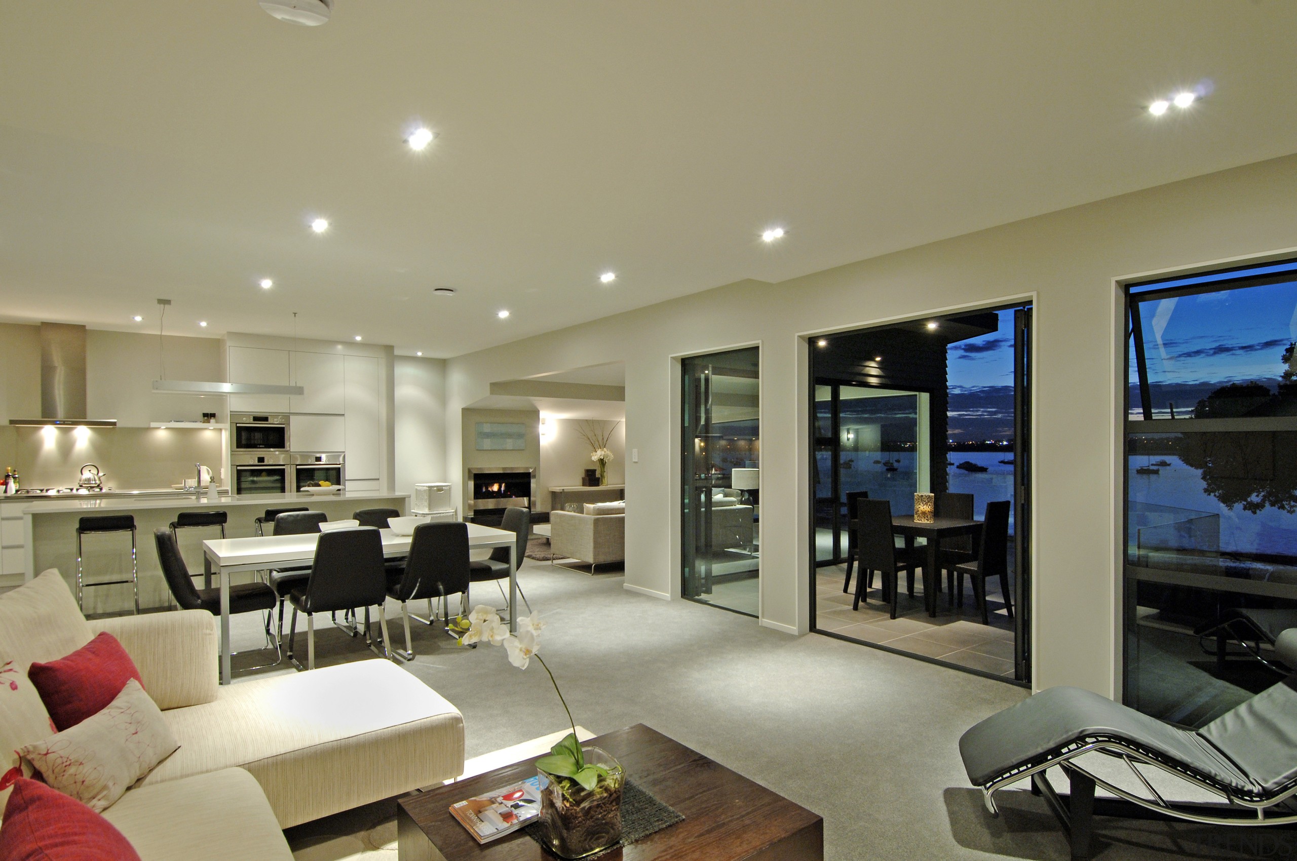 Interior view of an open-plan living area including apartment, ceiling, home, interior design, living room, penthouse apartment, property, real estate, orange, brown